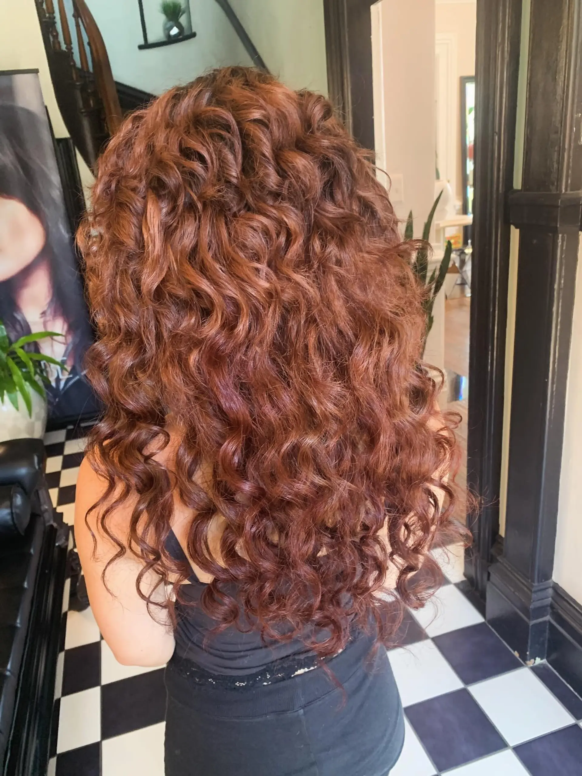 Long, dimensional auburn hair styled in full, defined cascading curls. 1