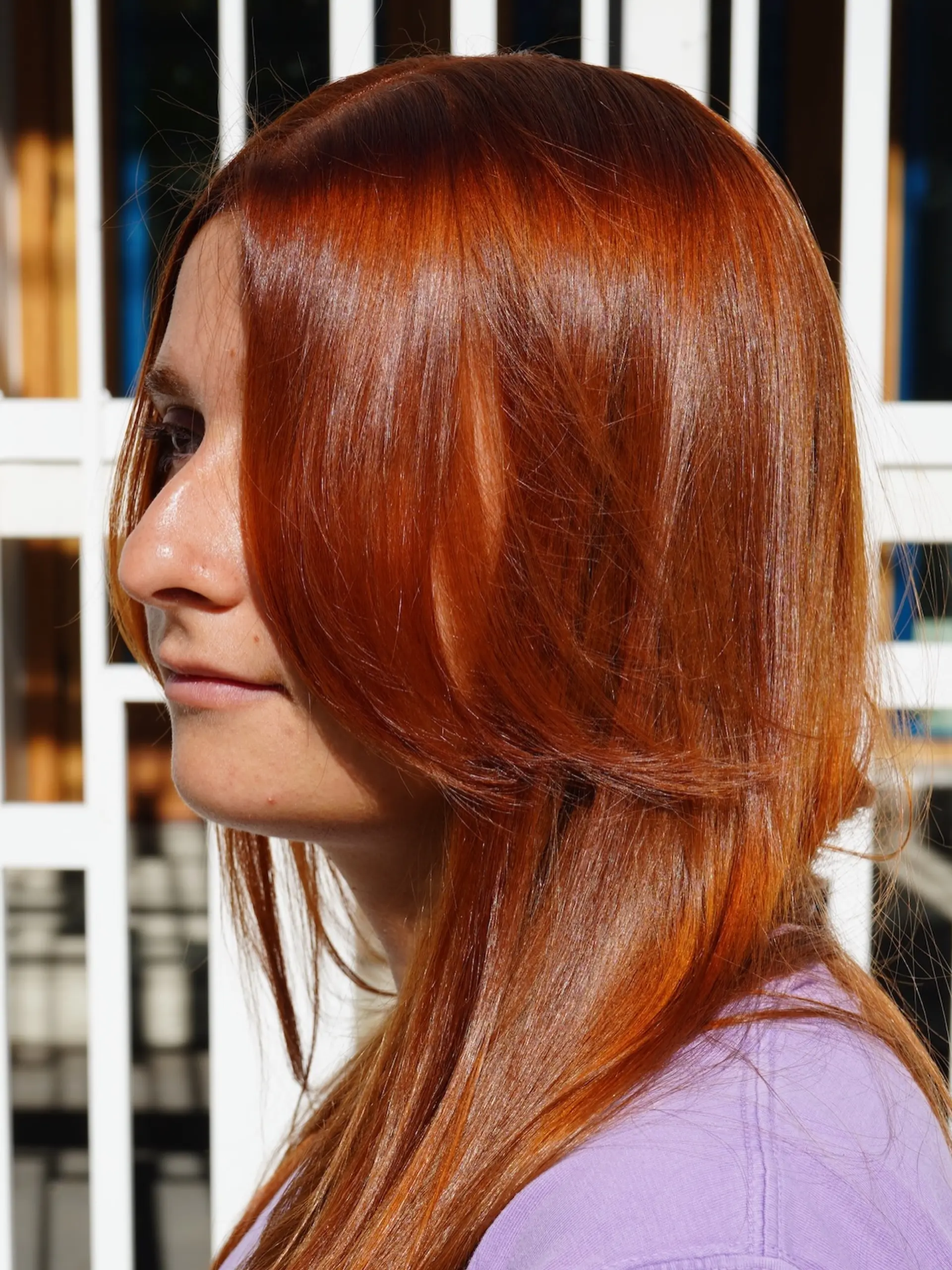 A vibrant copper all-over hair color on long, sleek straight hair with soft face-framing layers. 1