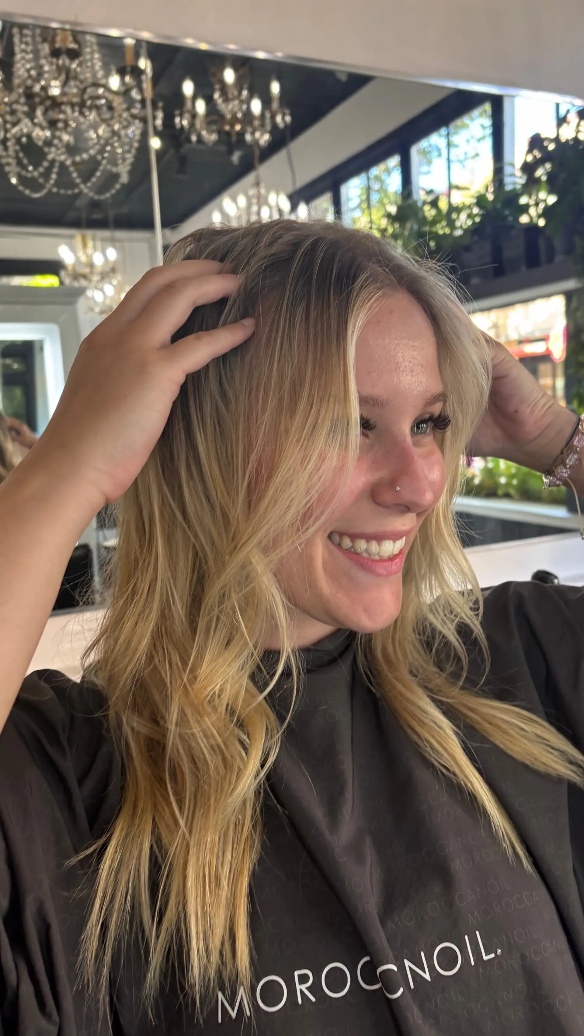 Long blonde hair with seamless extensions, styled in soft natural waves with face-framing strands. 1