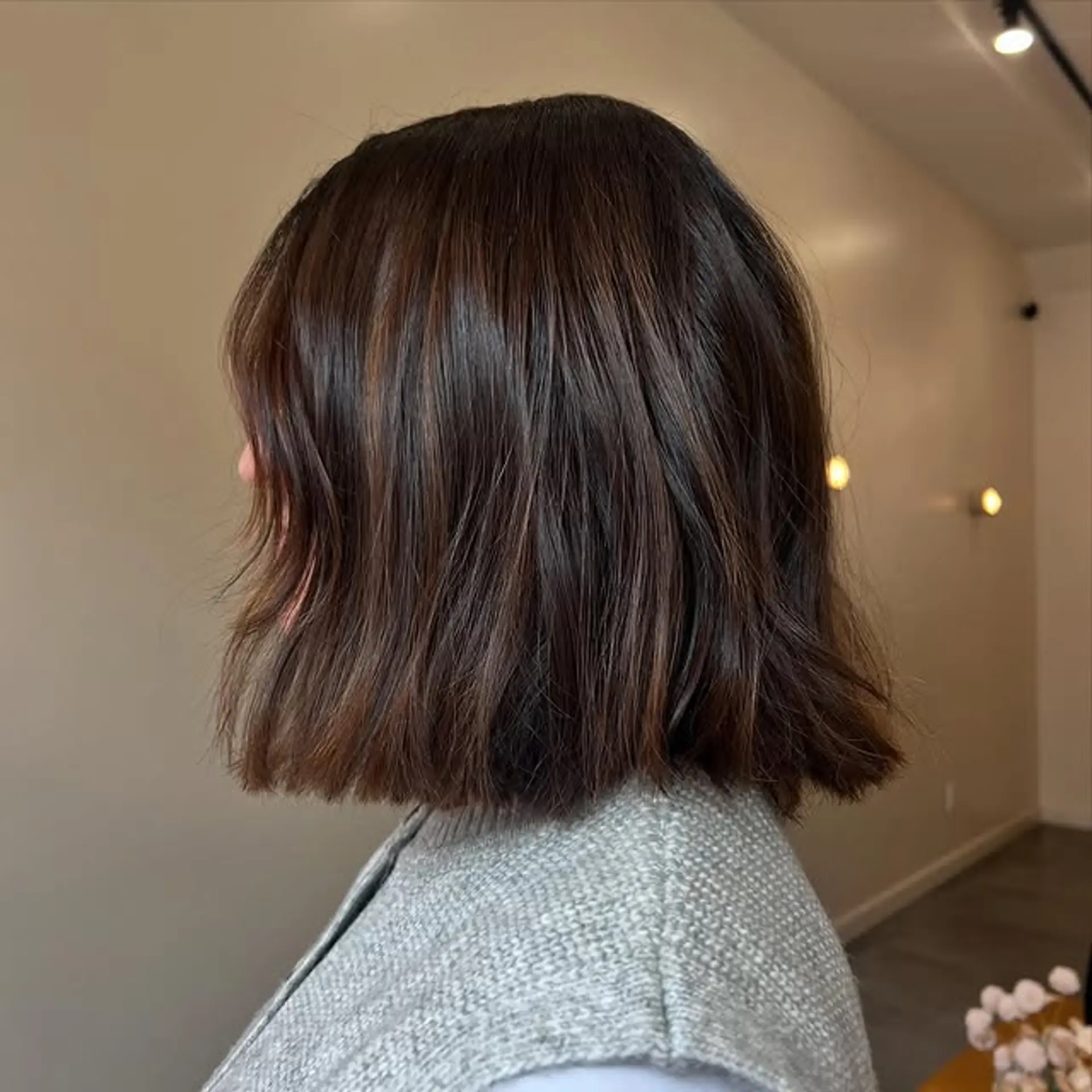 A trendy wavy lob with subtle caramel highlights. 1