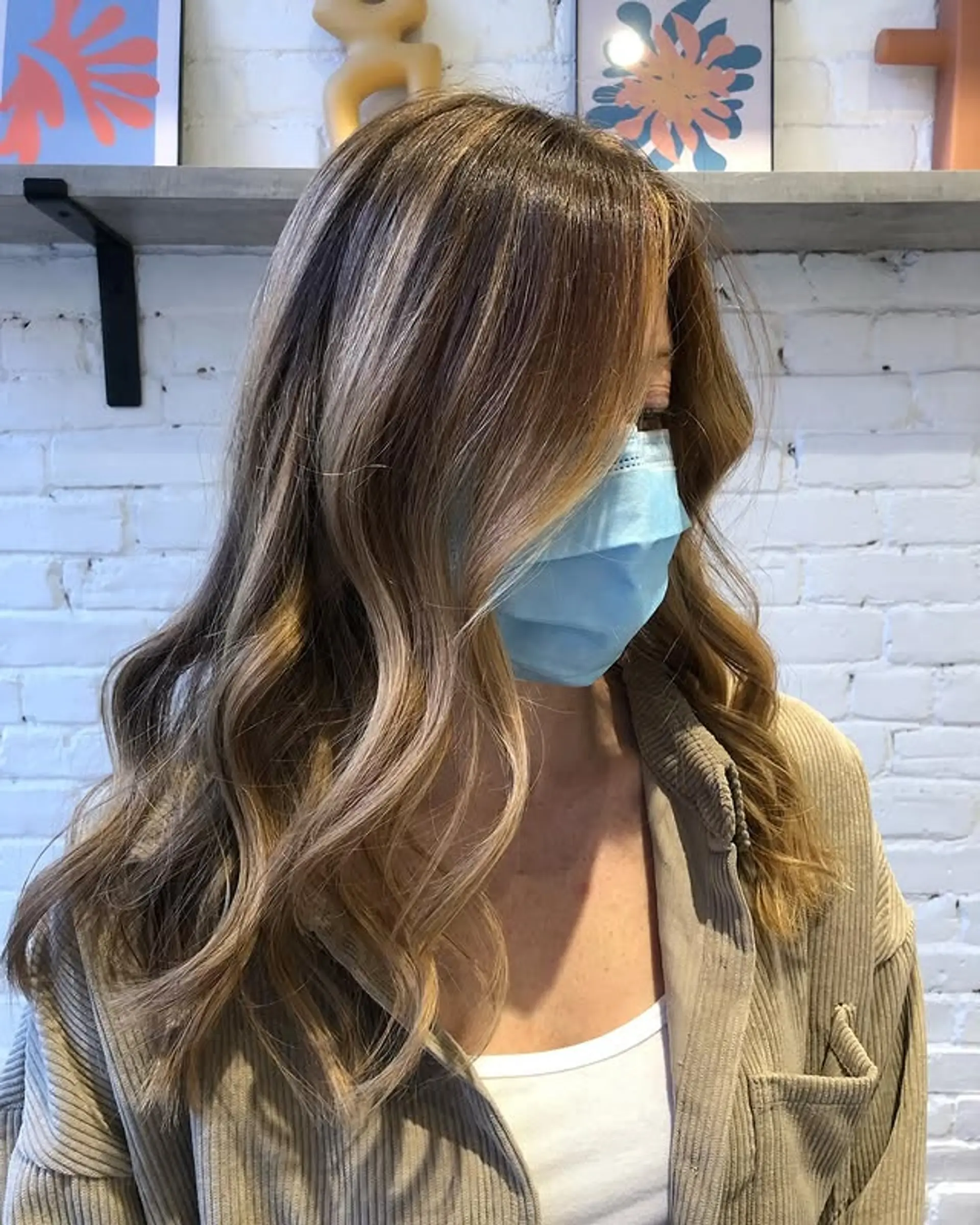 A medium-length wavy hairstyle with a caramel swirl balayage. 1