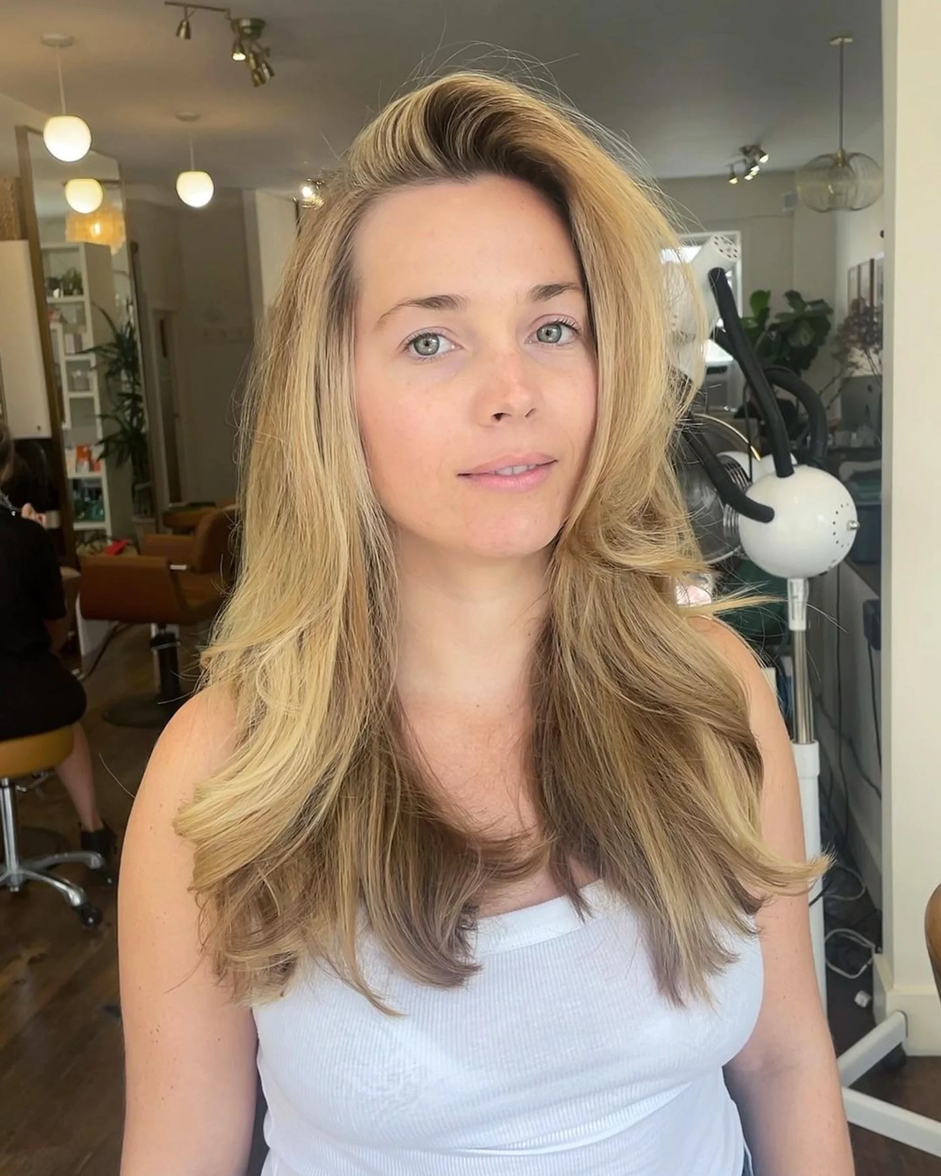 Voluminous 90s layered blowout with soft waves and curtain bangs - Preview 2