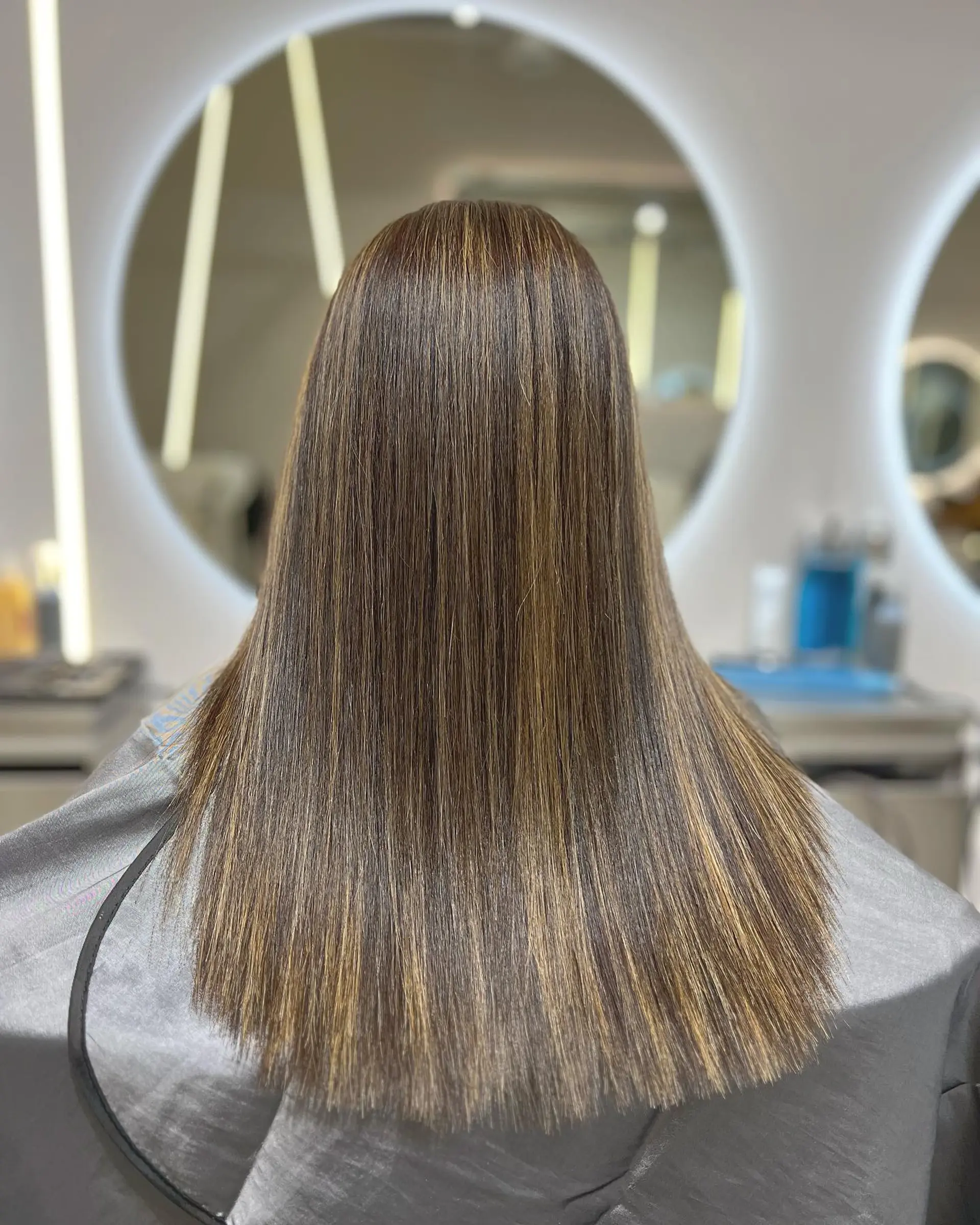 Long, straight hair with a bronde balayage and layered cut. 1