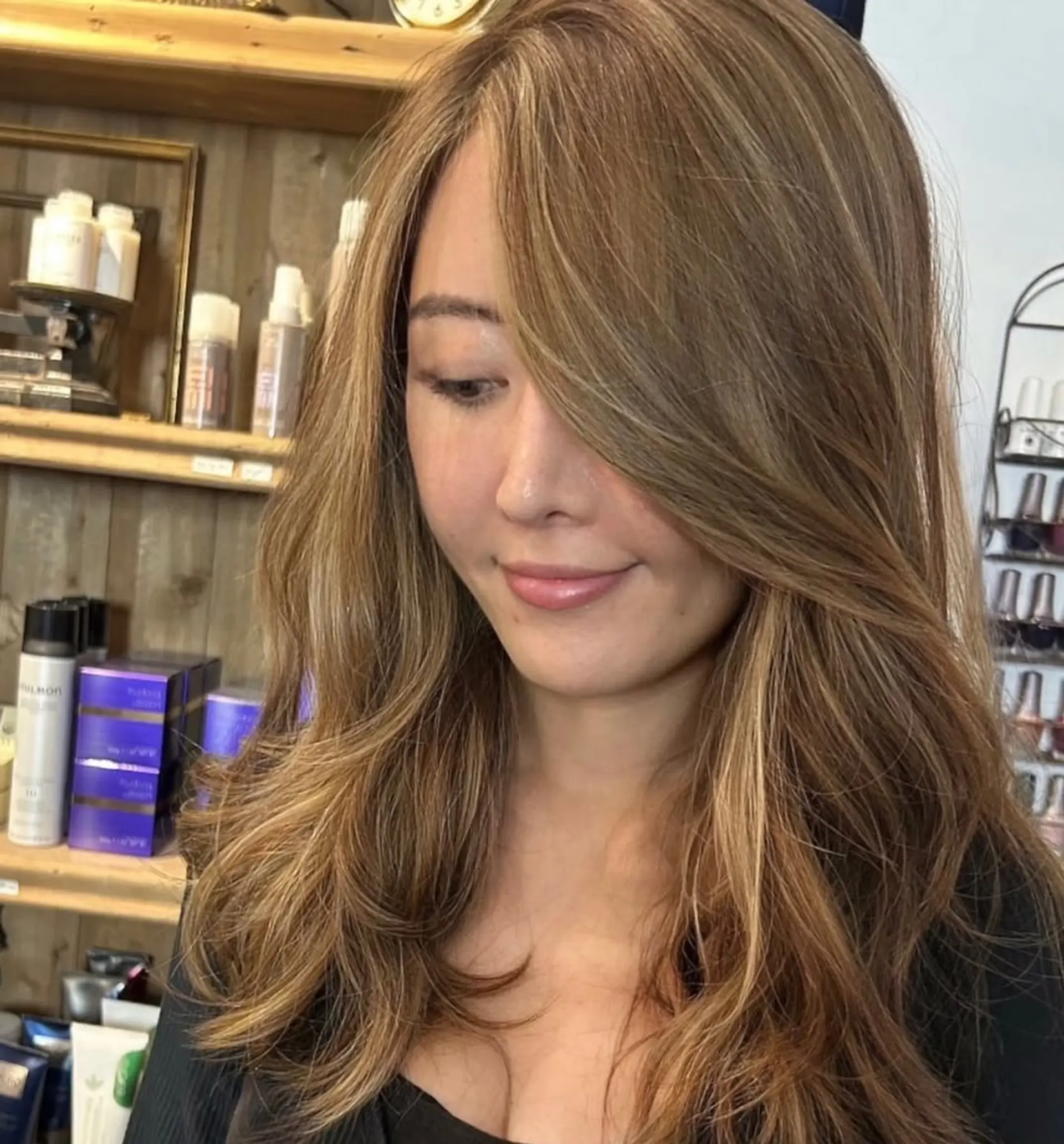 Beautifully styled long, wavy hair with light brown and golden blonde highlights, featuring soft curls and natural volume for an elegant look. 3