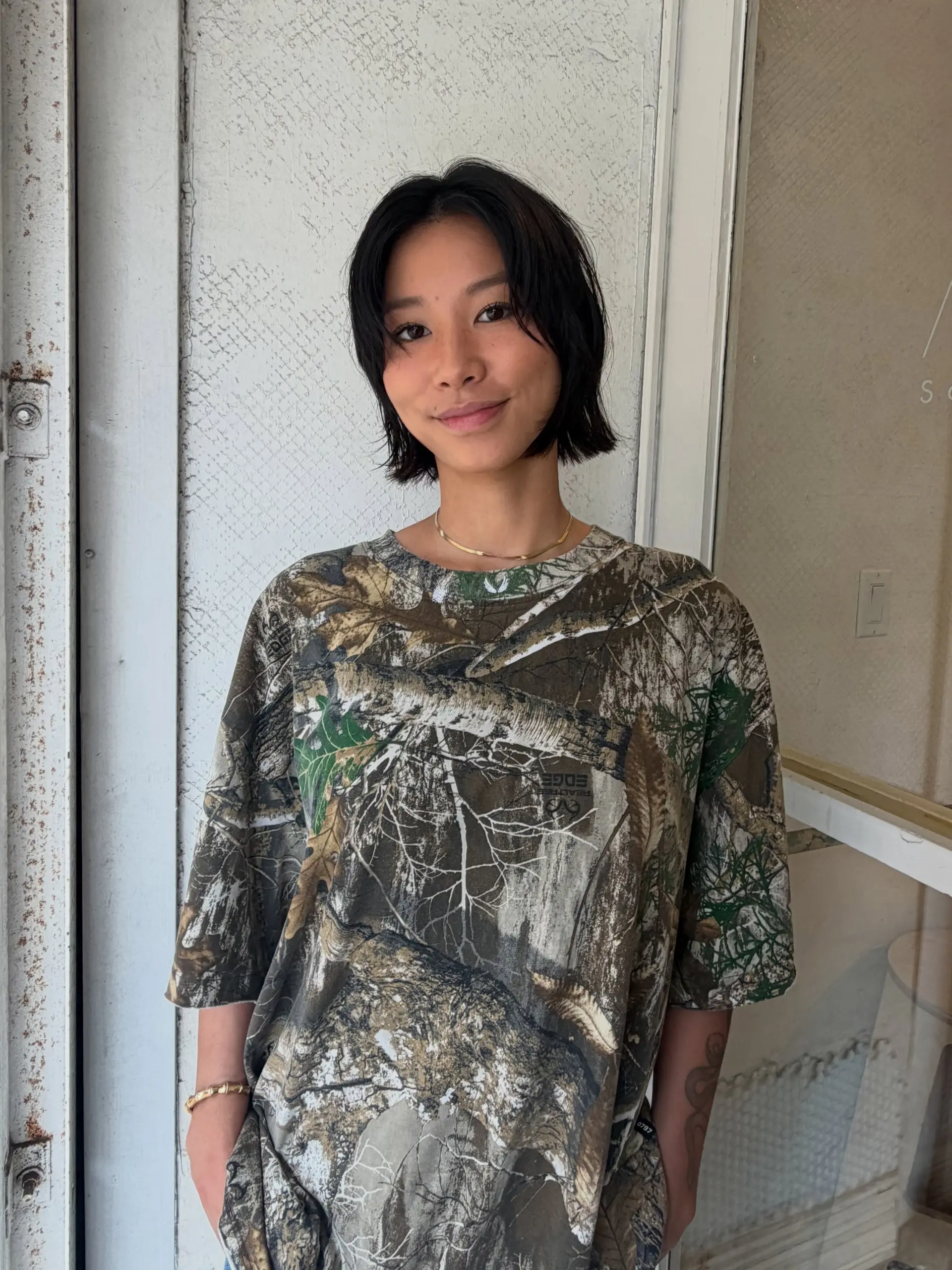 A soft, chin-length layered bob featuring light interior layering, textured ends, and face-framing pieces parted down the center. 1