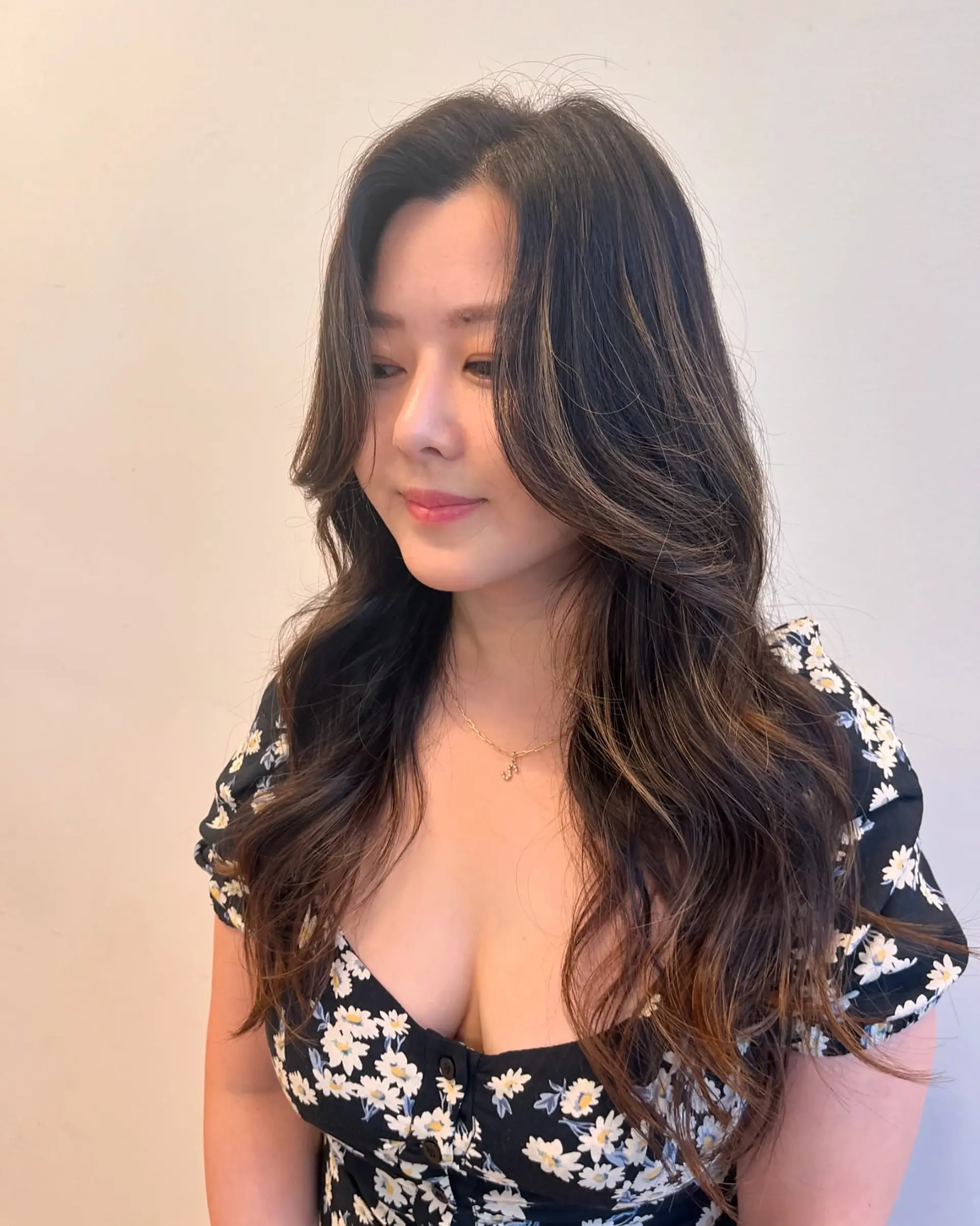 Long, soft waves with face-framing layers and subtle caramel highlights. 1