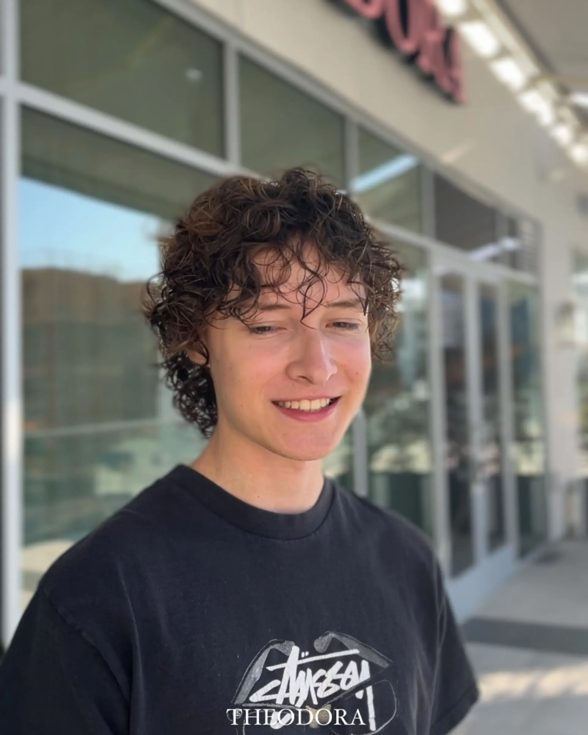 A modern mullet with defined curls and a textured top. 1