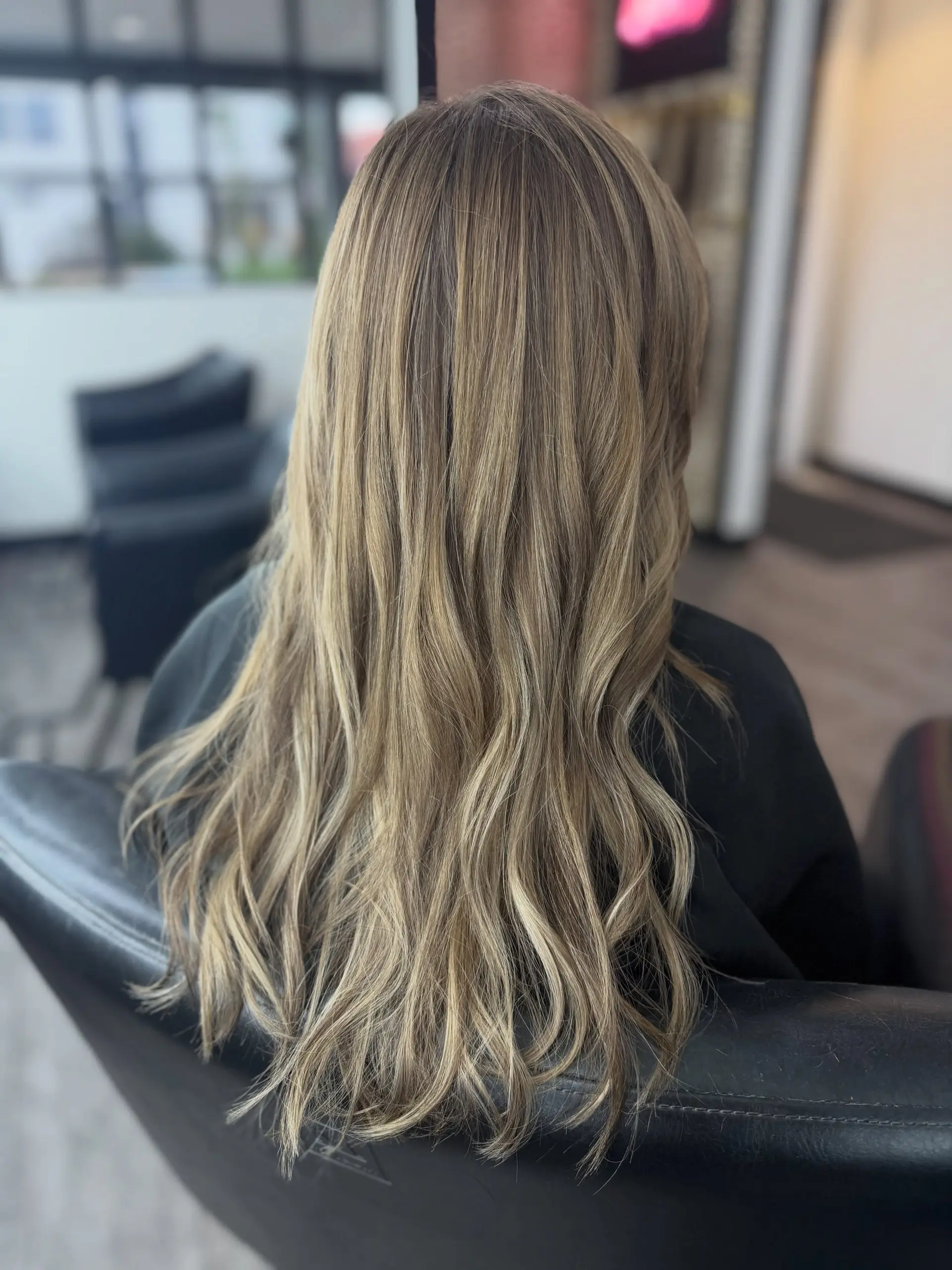Long beige blonde hair with soft lowlight depth, bright dimensional highlights, and subtle loose waves. 1