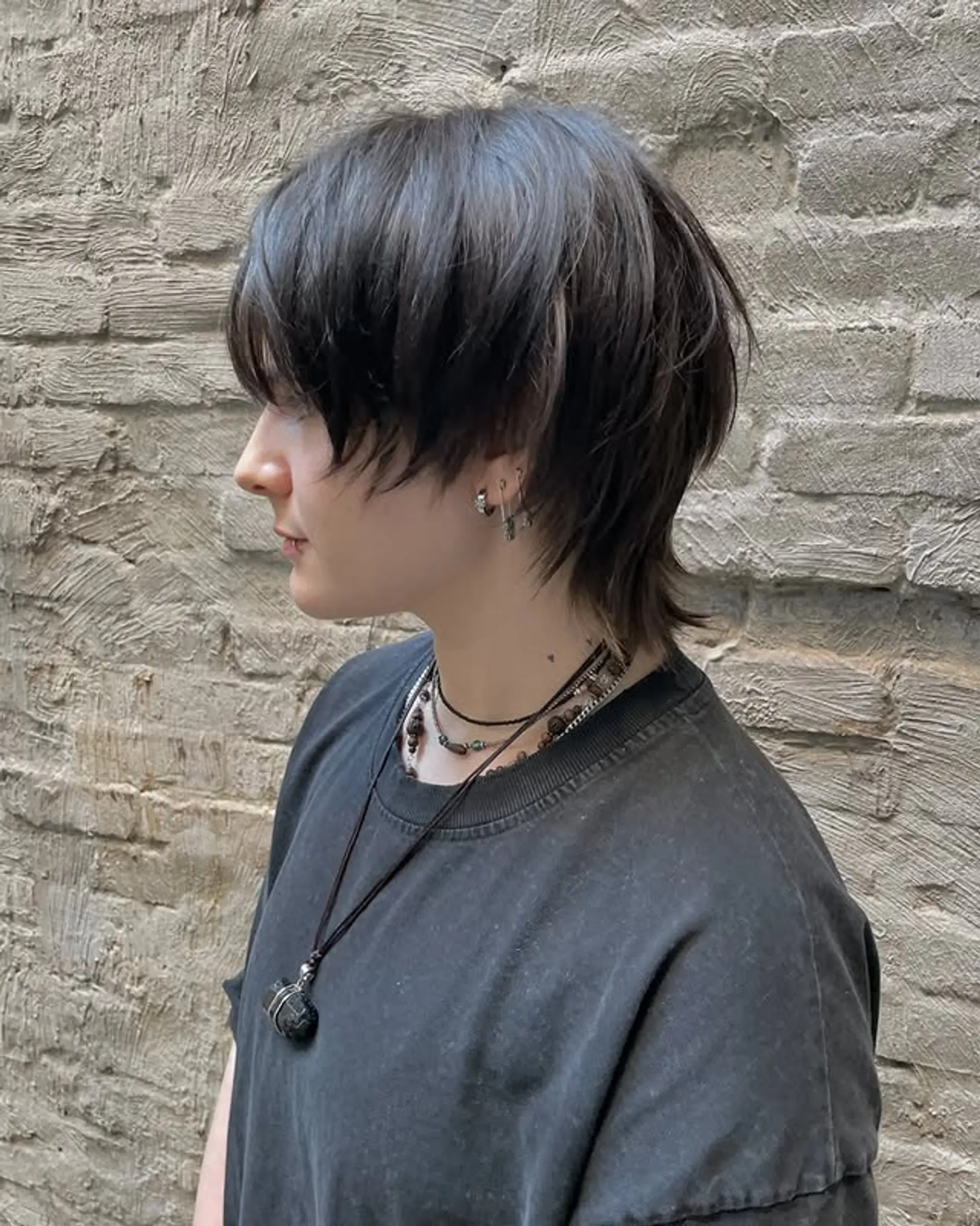 A modern take on the classic mullet, featuring shaggy layers and textured bangs for an edgy, effortless look. 1