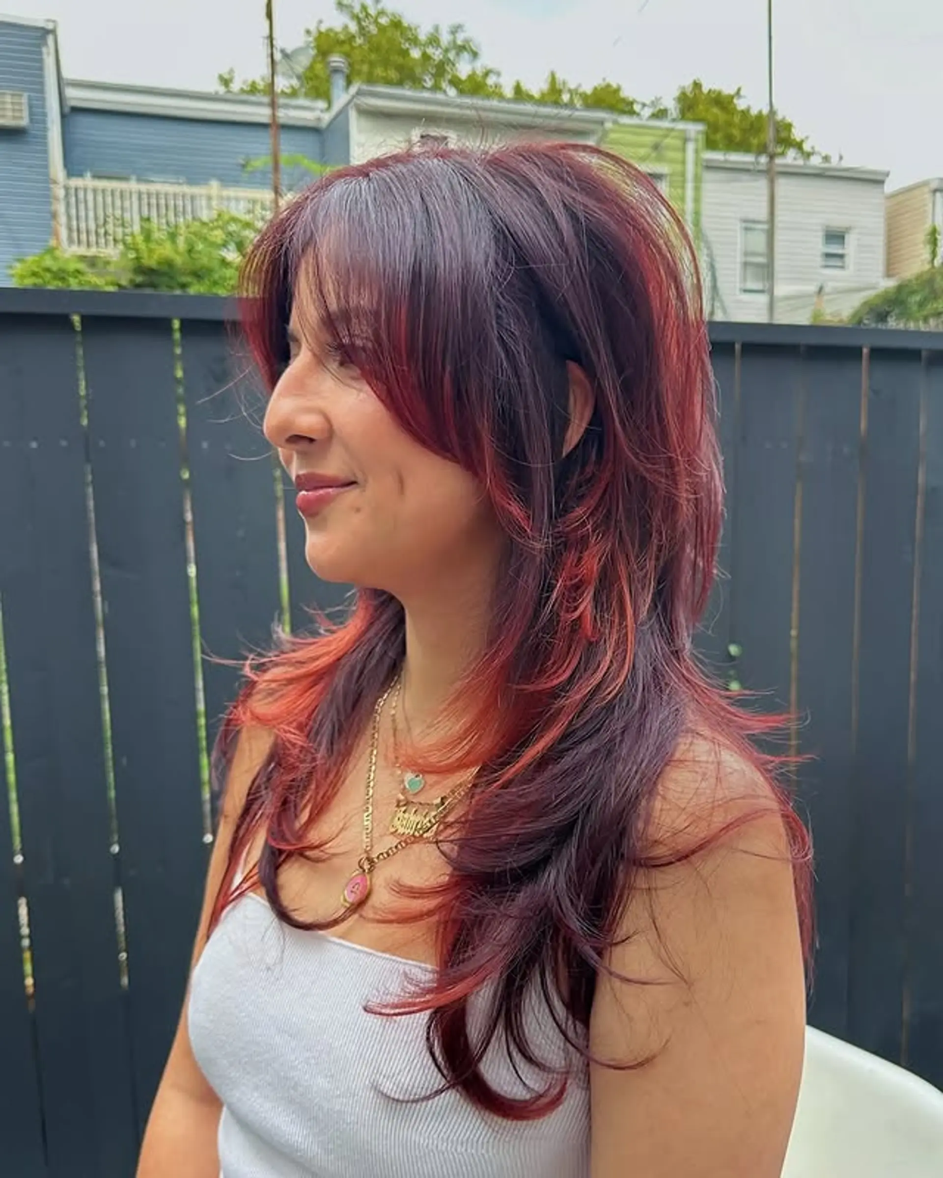 A medium-length wavy shag with choppy layers and long curtain bangs. 1