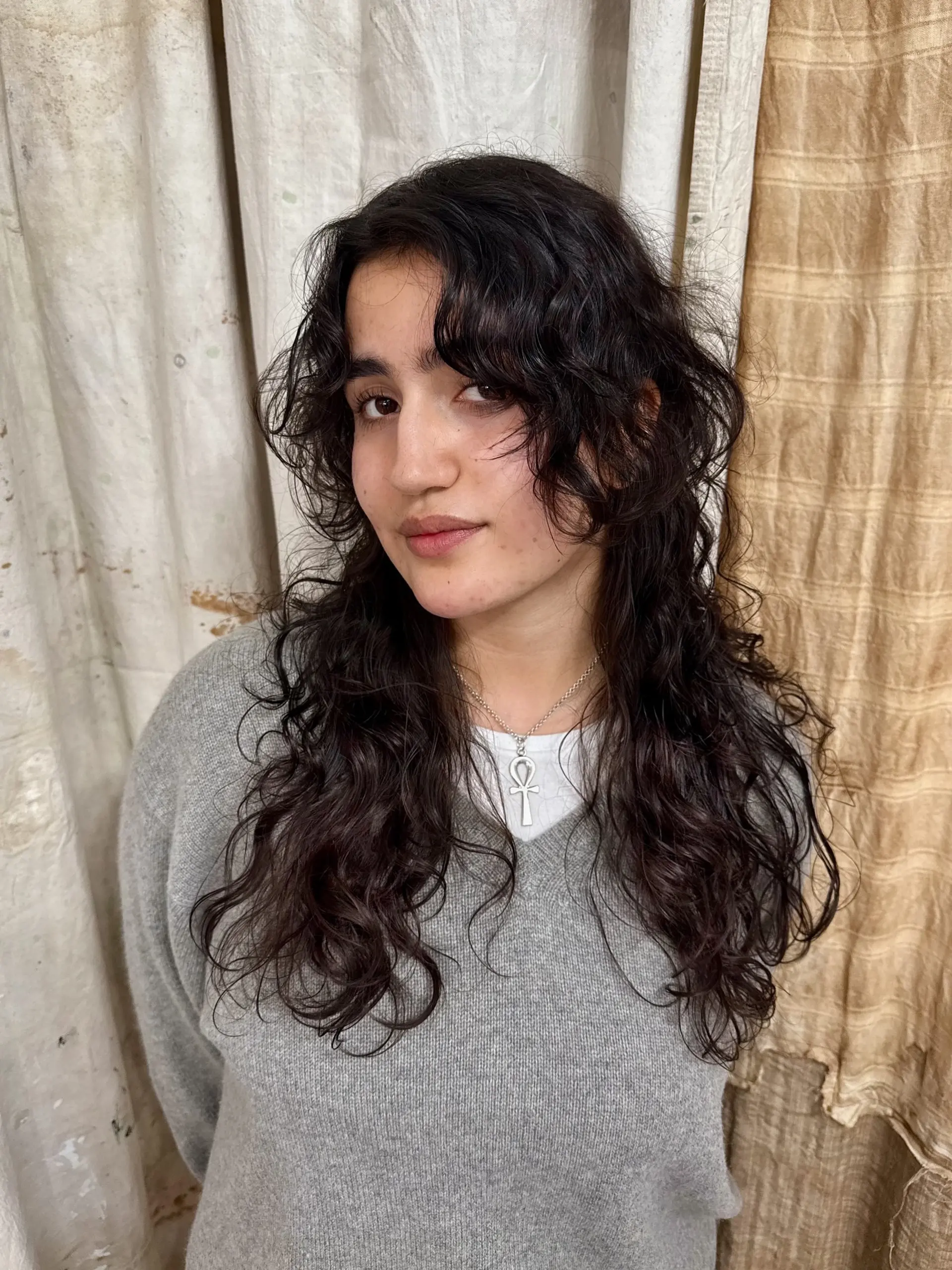 A trendy long shag with feathered layers to enhance natural curls. 1