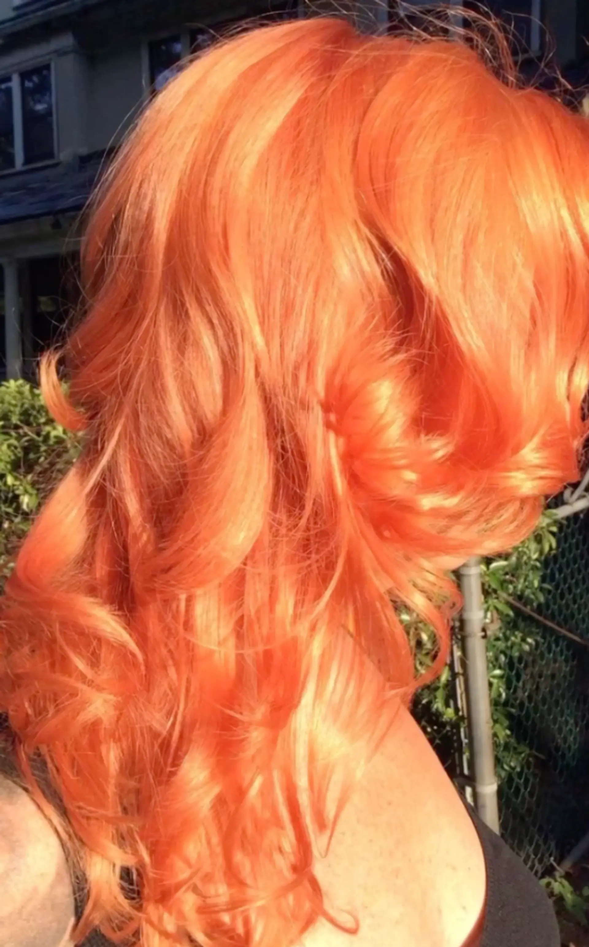 A medium-length wavy hairstyle with vibrant, textured waves and a bold copper color. 1