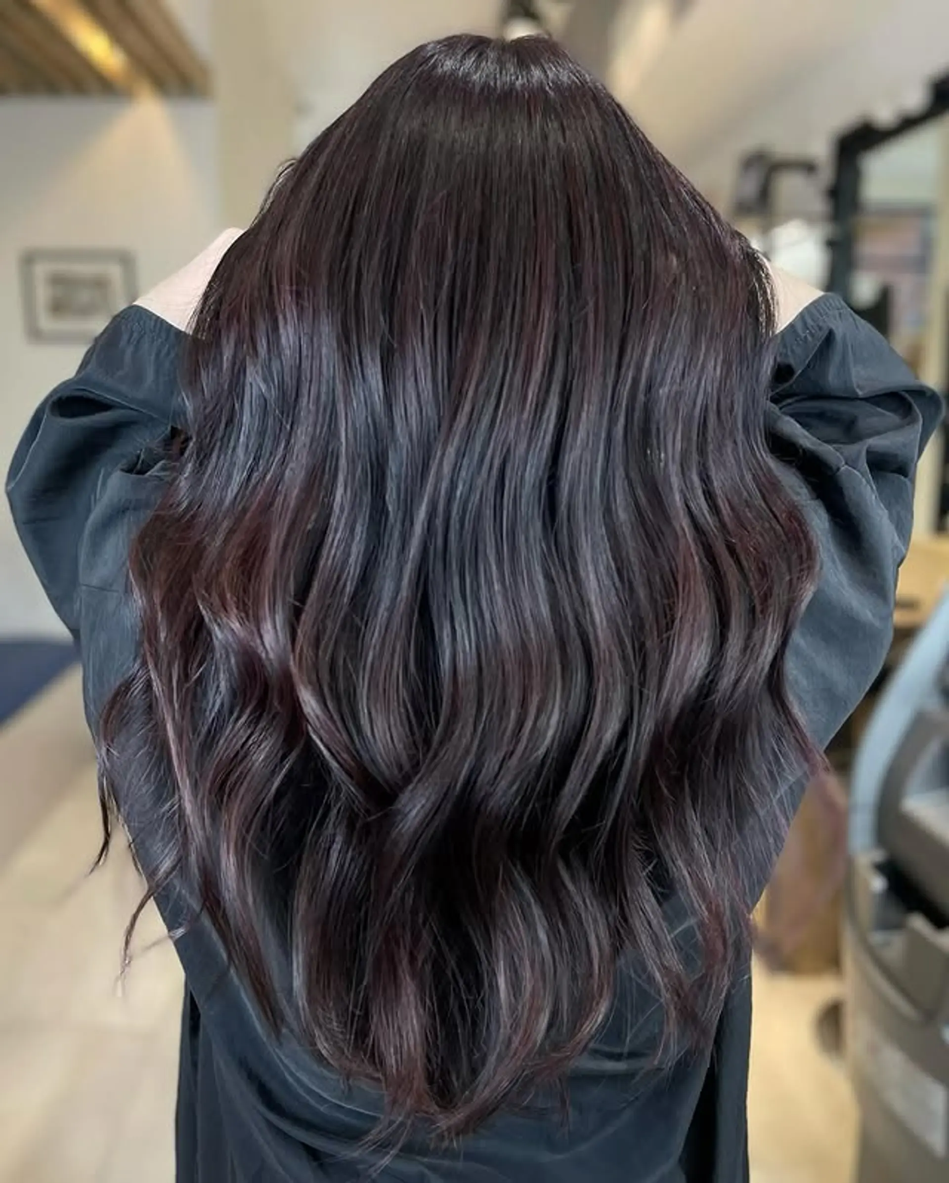 A long, wavy hairstyle with a subtle burgundy balayage. 1