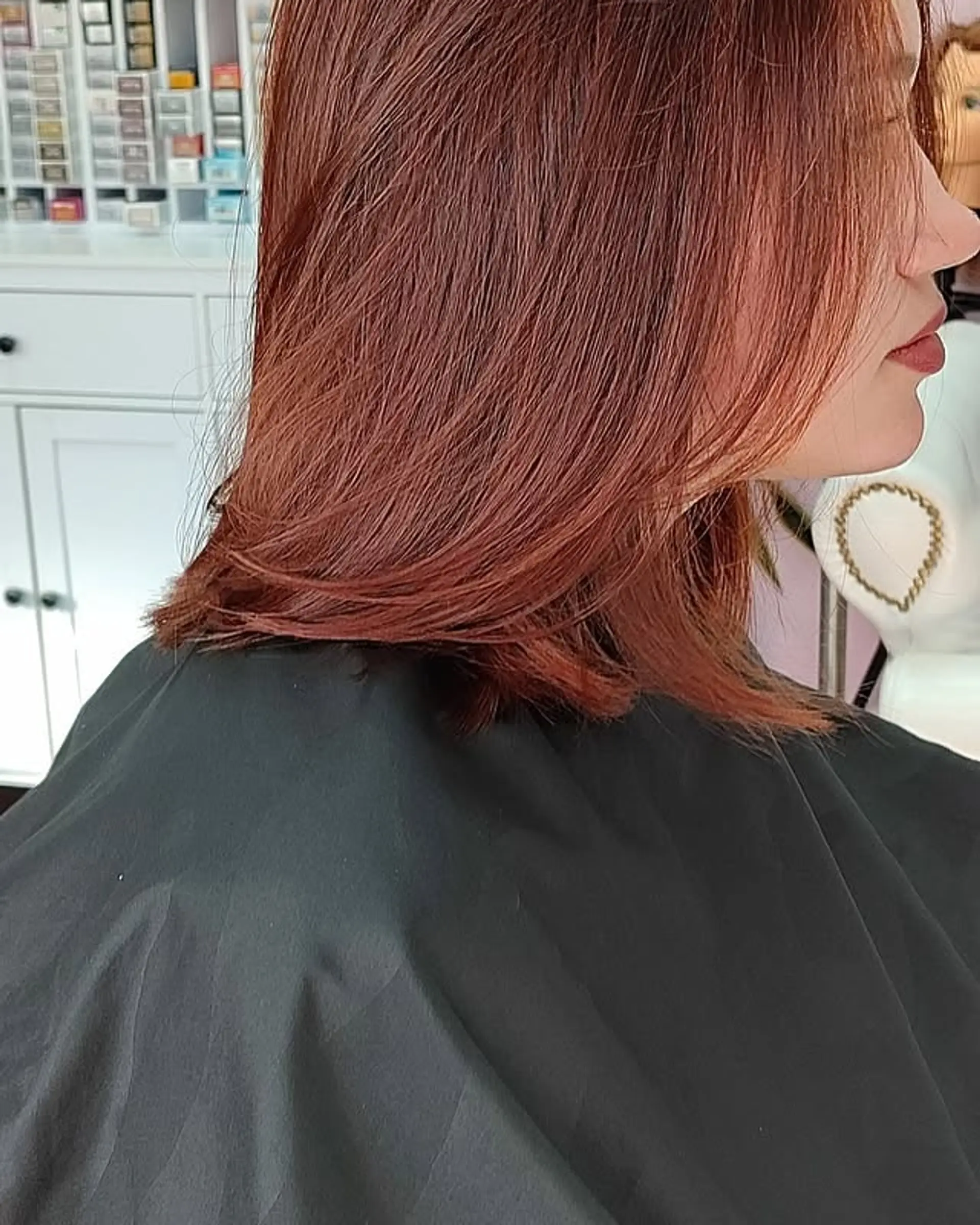 A medium-length bob with a blunt cut, styled in a vibrant copper red color. 1