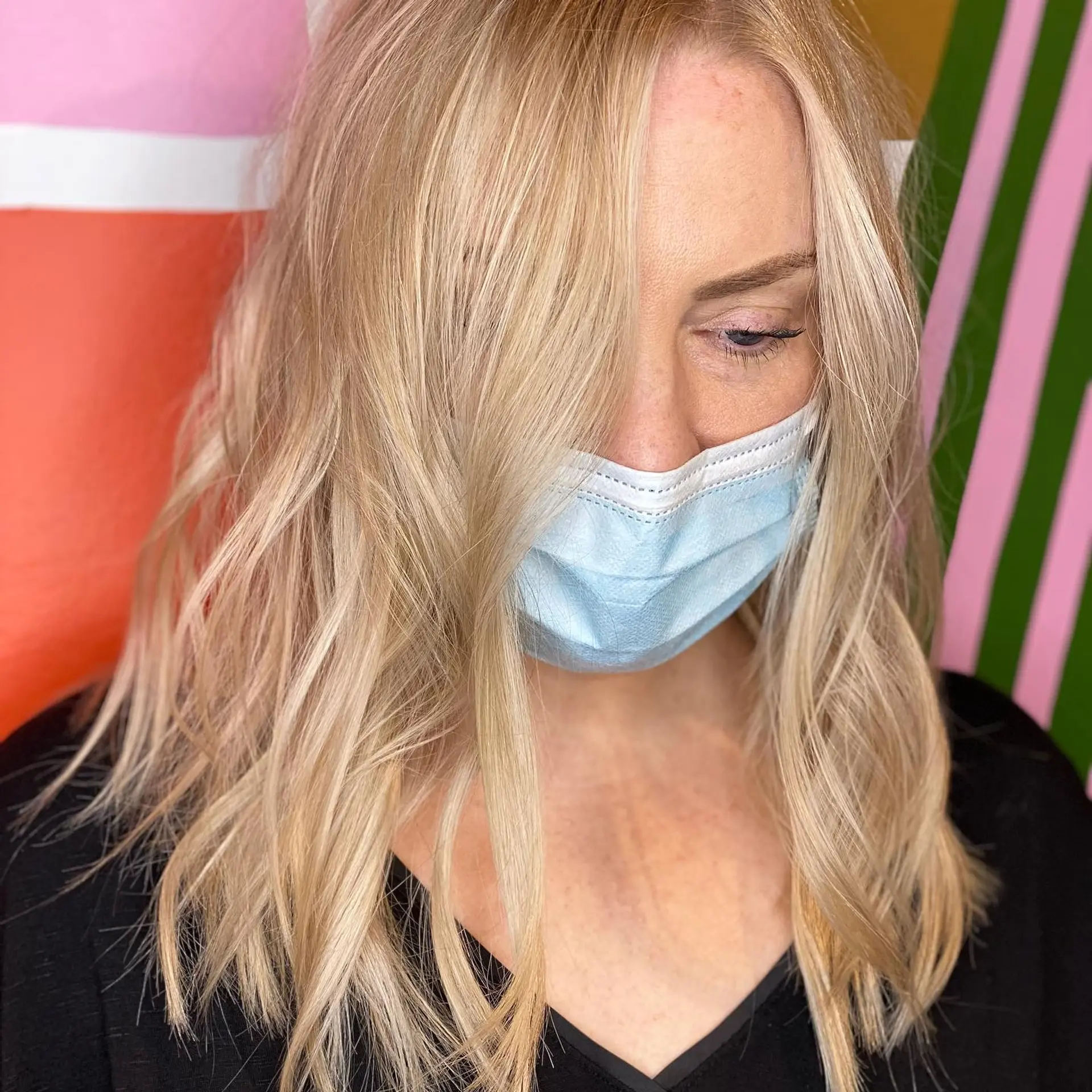 Medium-length bright golden blonde hair styled in soft, tousled waves with face-framing layers. 1
