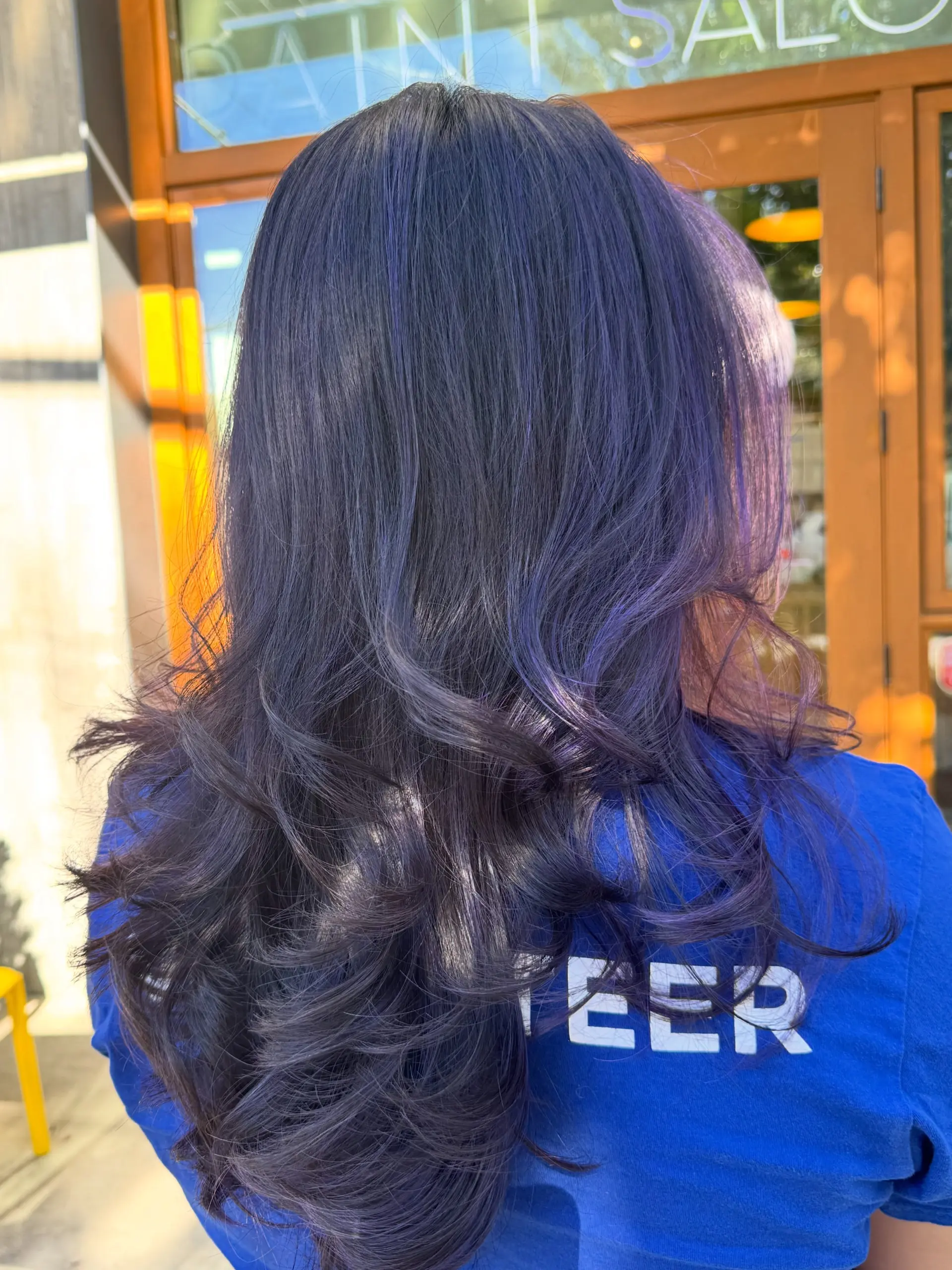 Long deep purple and violet wavy hair styled with soft, loose curls at the ends. 1