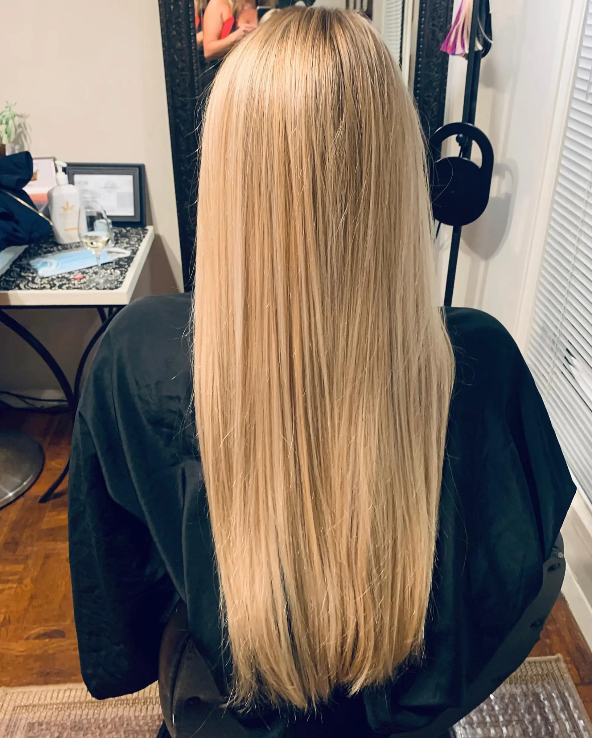 Extra-long, sleek straight hair featuring a dimensional blonde-on-blonde balayage. 1
