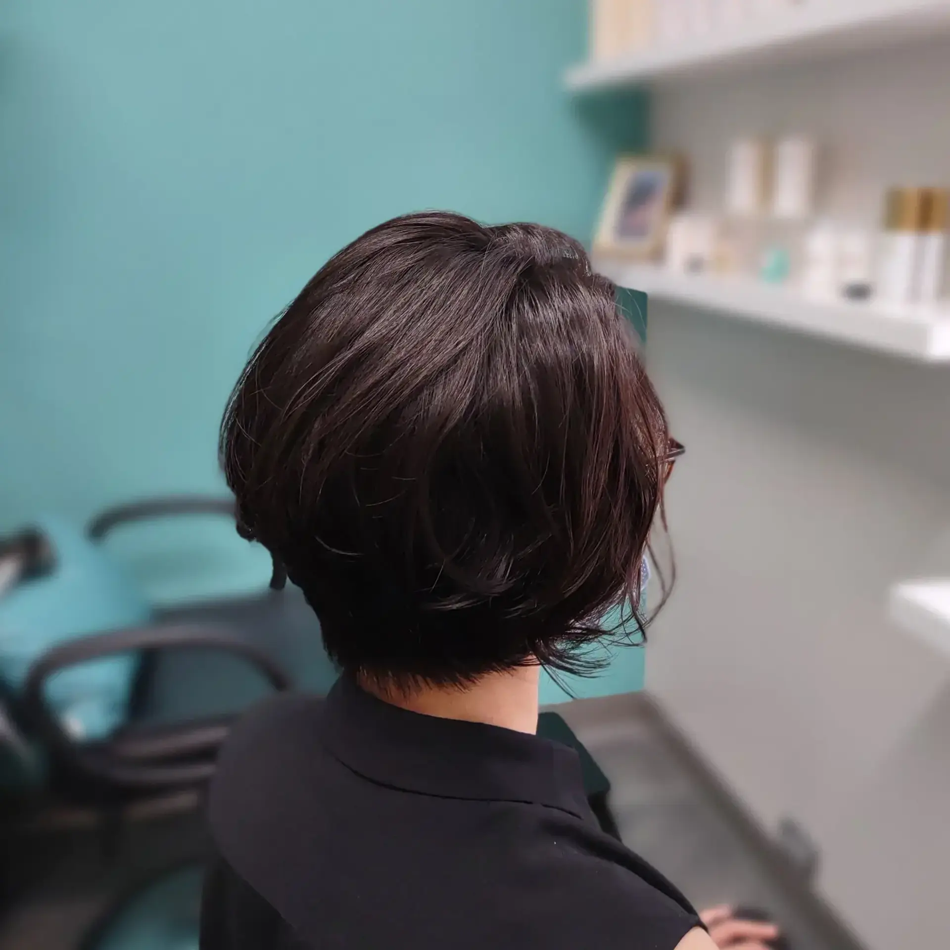 A textured short bob haircut featuring rounded volume and gentle piecey layers tapering at the nape. 1