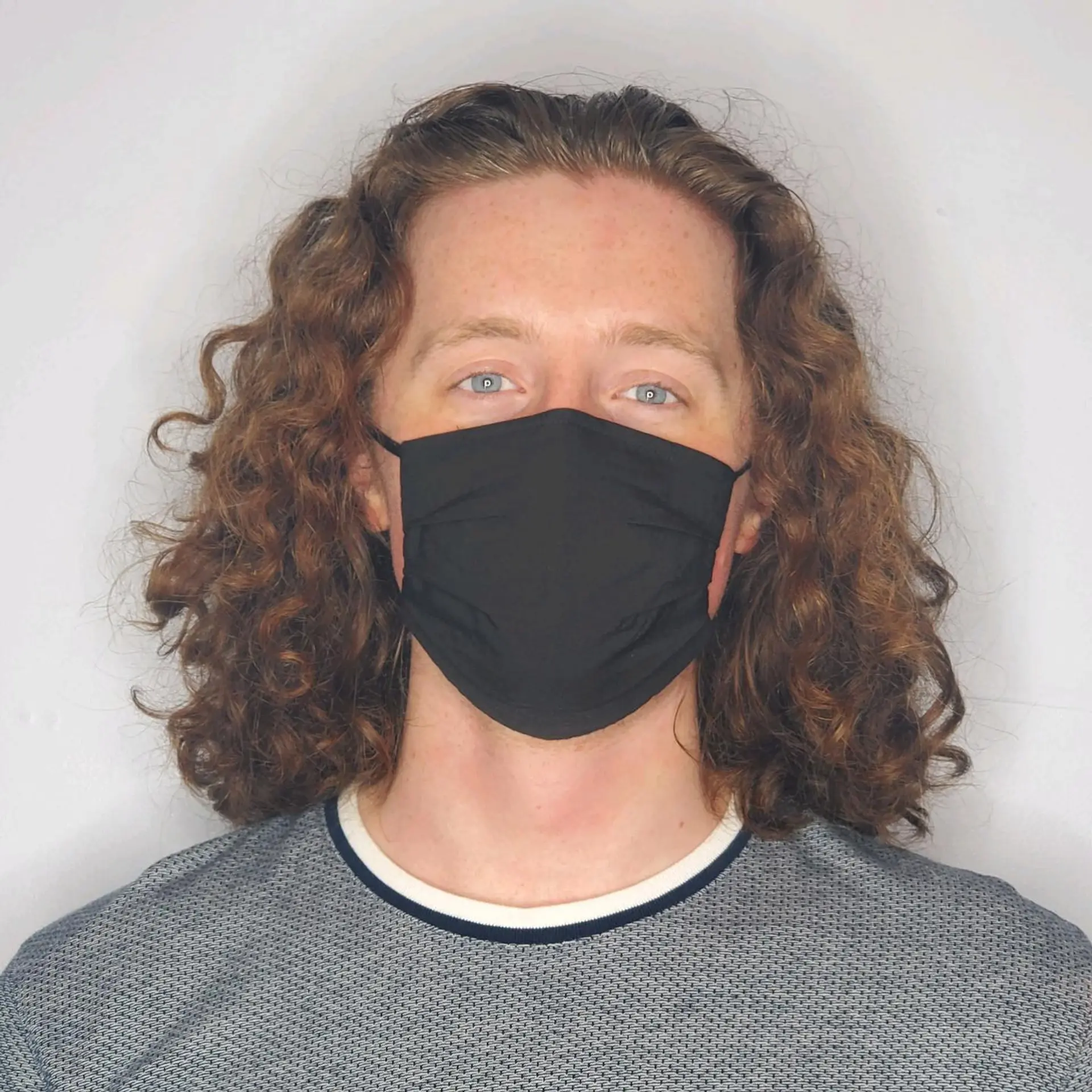 Medium-length curly cut styled with defined ringlets, rich texture, and natural volume. 1