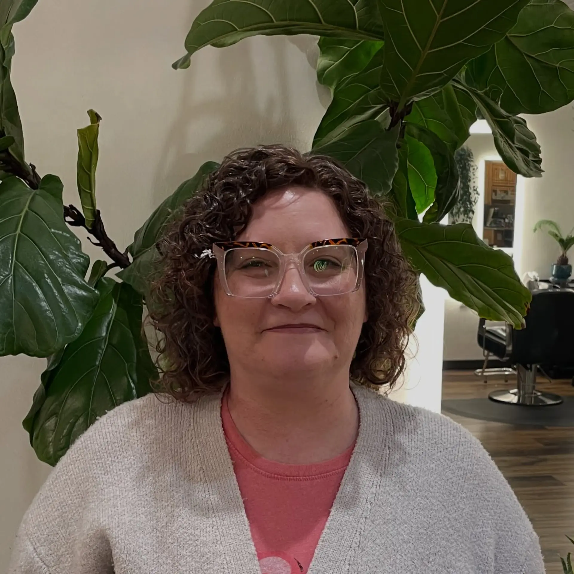 A defined, rounded curly bob cut framing the face with springy, textured ringlets. 1