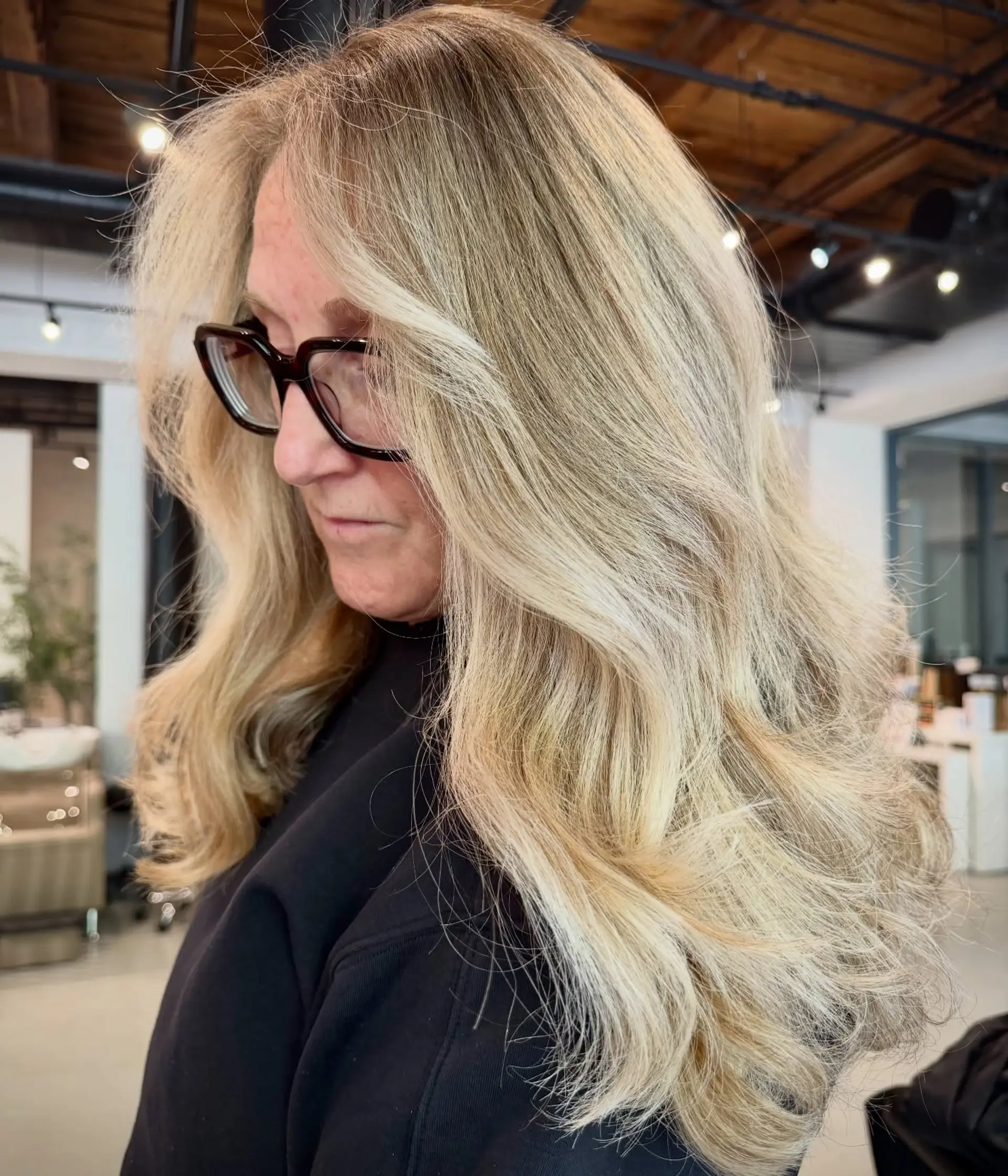 Long seamless airtouch blonde hair styled with soft, face-framing waves. 1