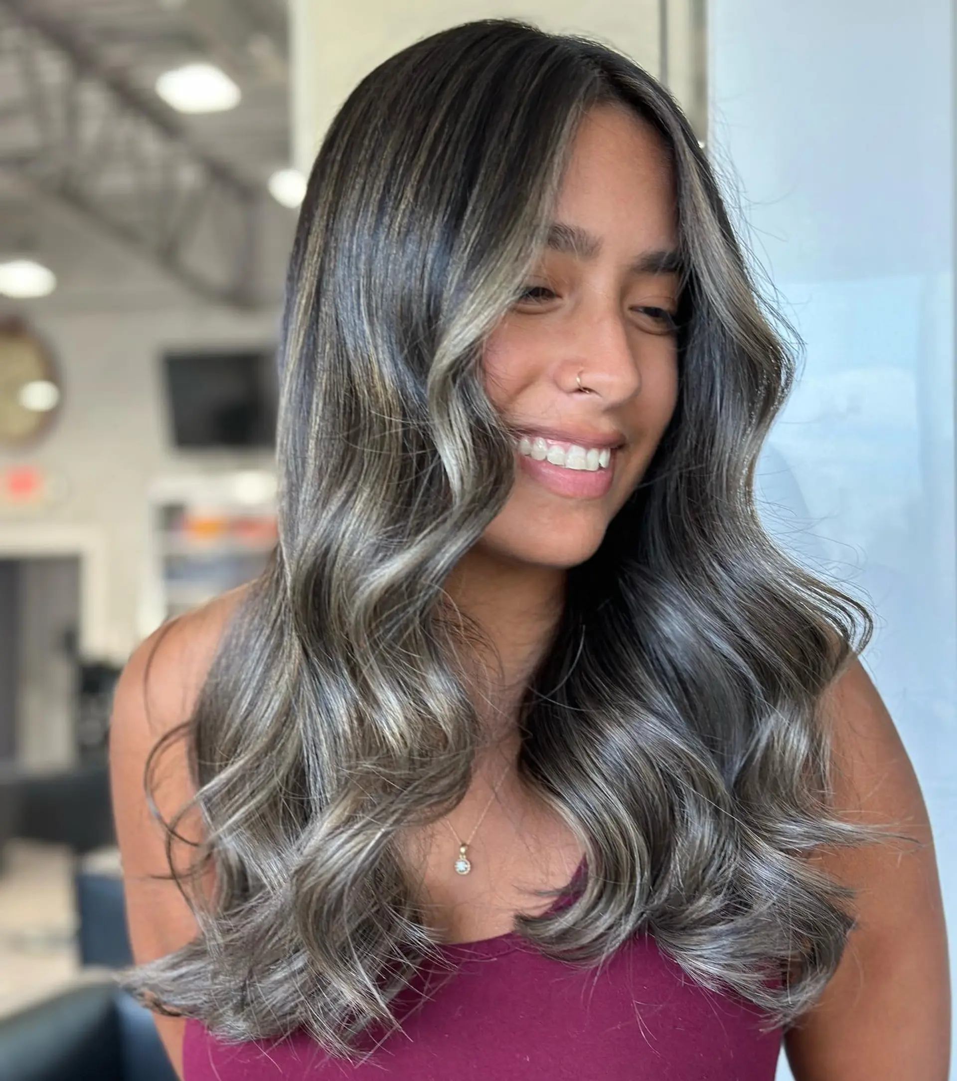 Long wavy hair with a smoked ash balayage for a dimensional and modern look. 1