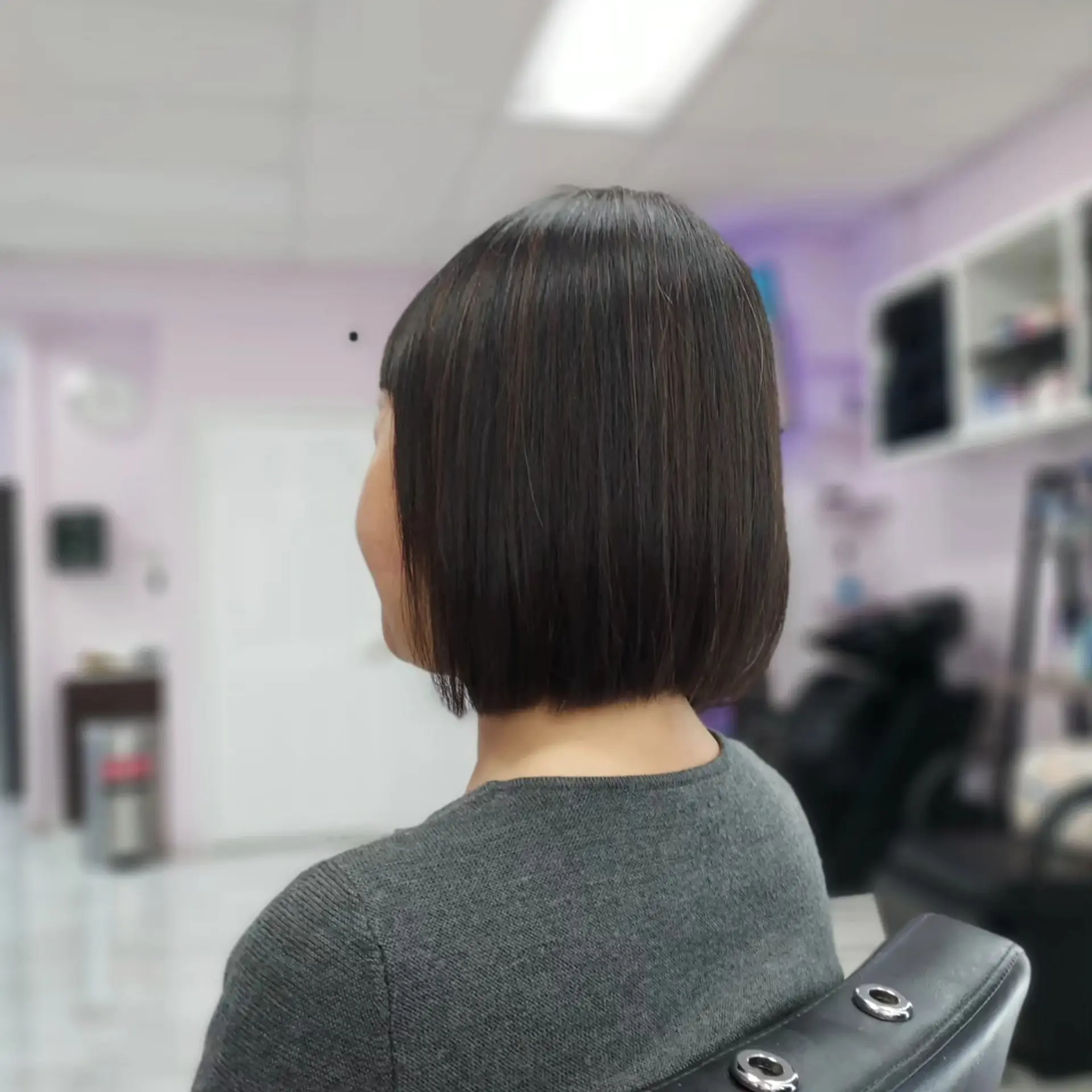 A sleek, chin-length blunt bob haircut styled smooth and straight. 1