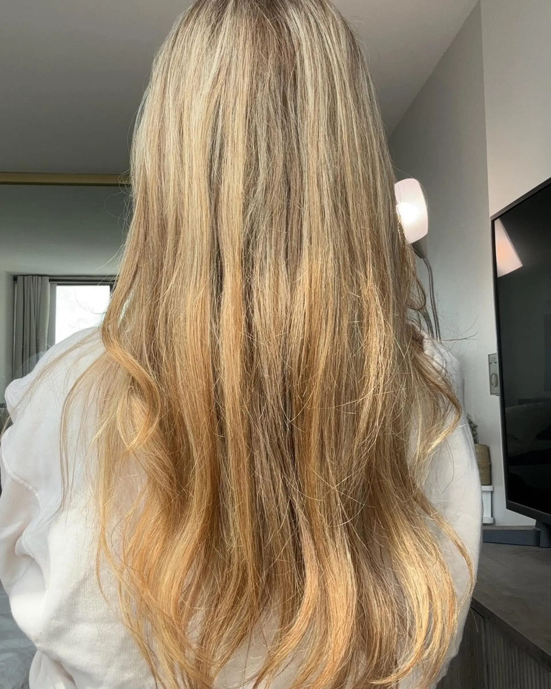 Long, flowing beachy waves with a subtle blonde balayage. 3