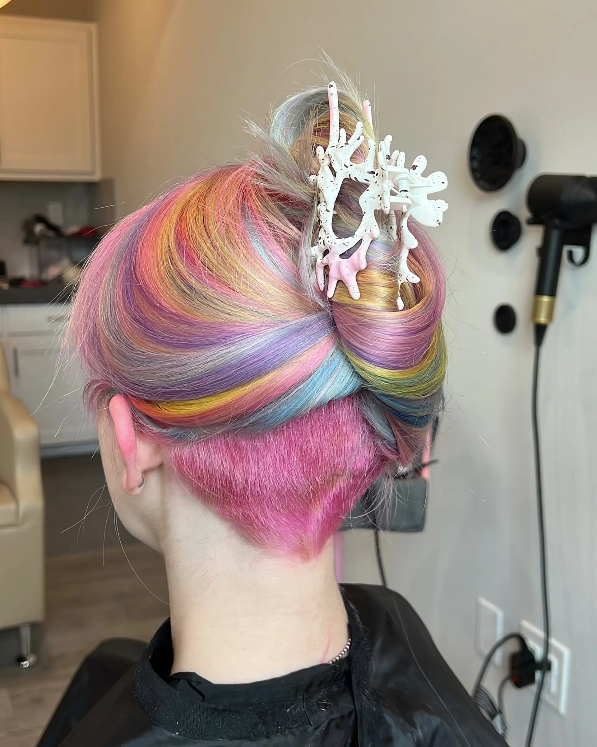 This eye-catching hairstyle showcases medium-length wavy hair adorned with a full spectrum of pastel rainbow colors, blended seamlessly for a magical, vivid, and whimsical unicorn effect. 3
