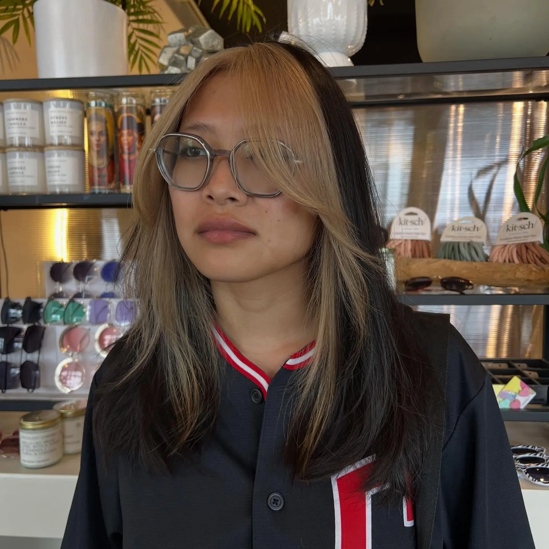 Medium-length dark brunette hair featuring bold blonde color blocking through the front fringe and face-framing layers. 1