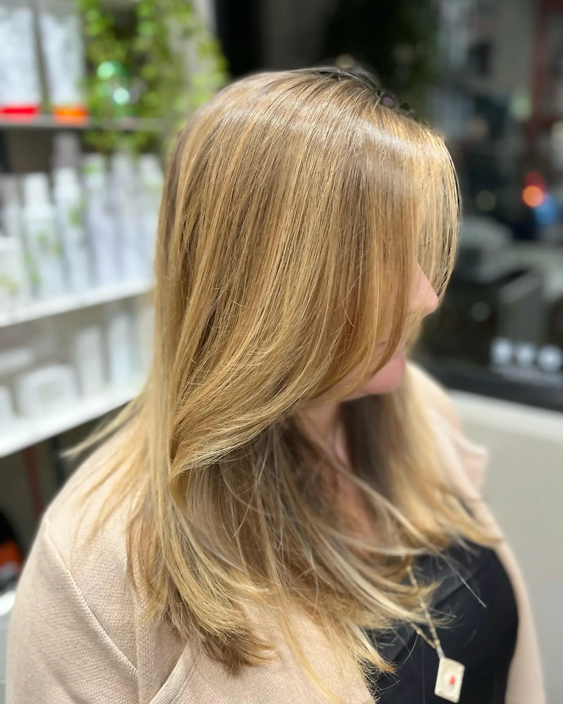 A medium-length layered haircut with face-framing layers and trendy curtain bangs. 1