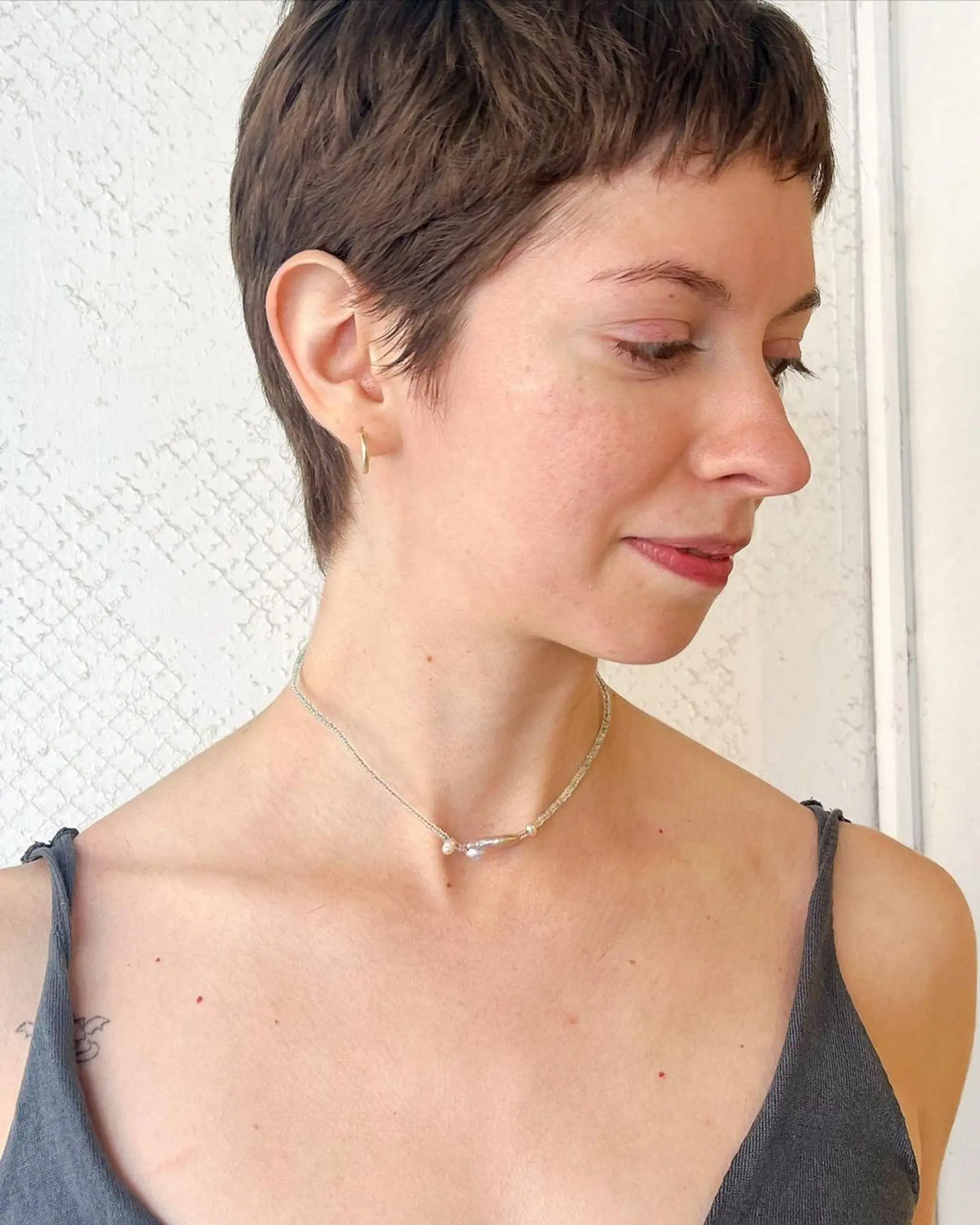 Chic pixie cut with short layers and textured edges, soft fringe for a natural, effortless look. 1