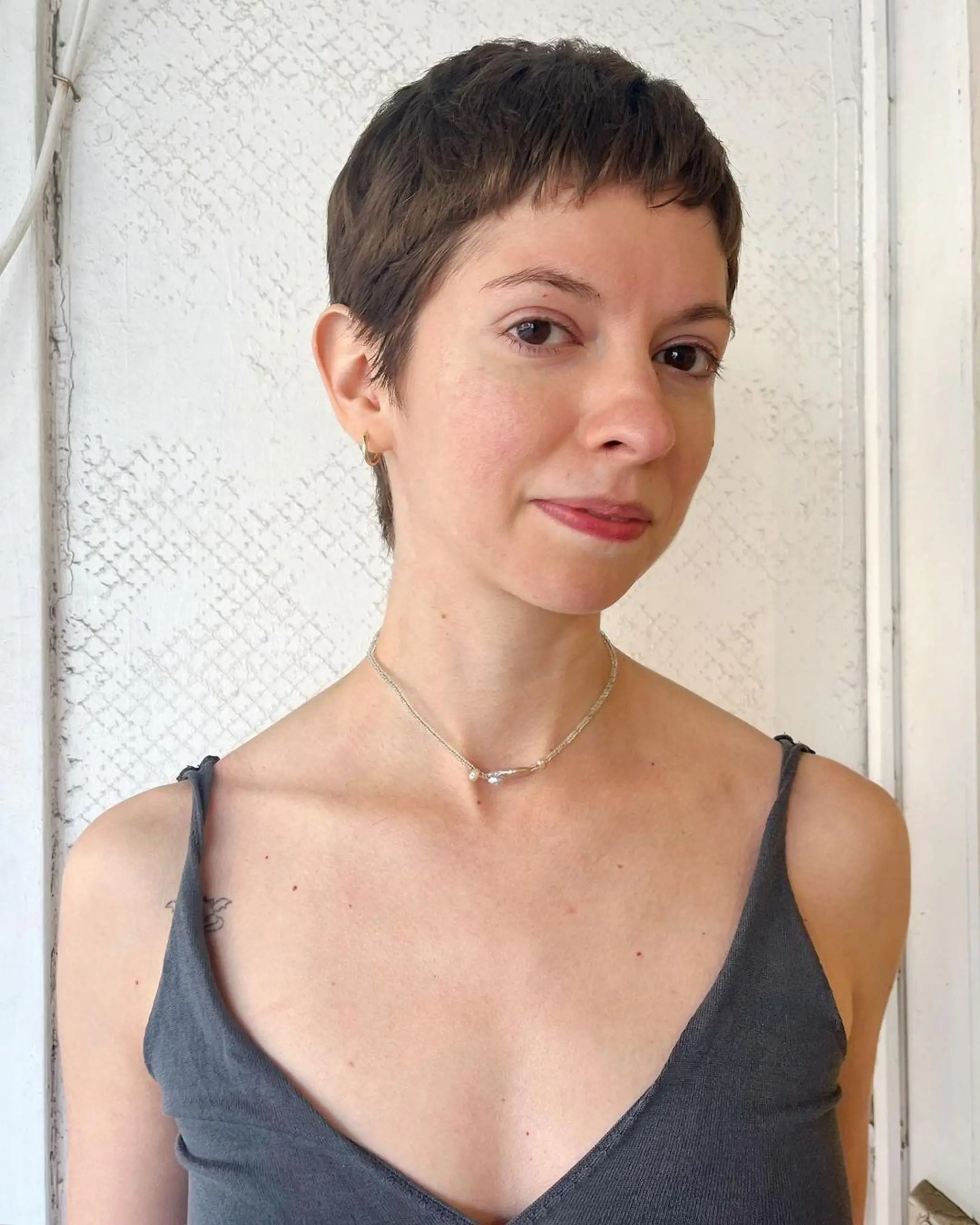 Chic pixie cut with short layers and textured edges, soft fringe for a natural, effortless look. 2