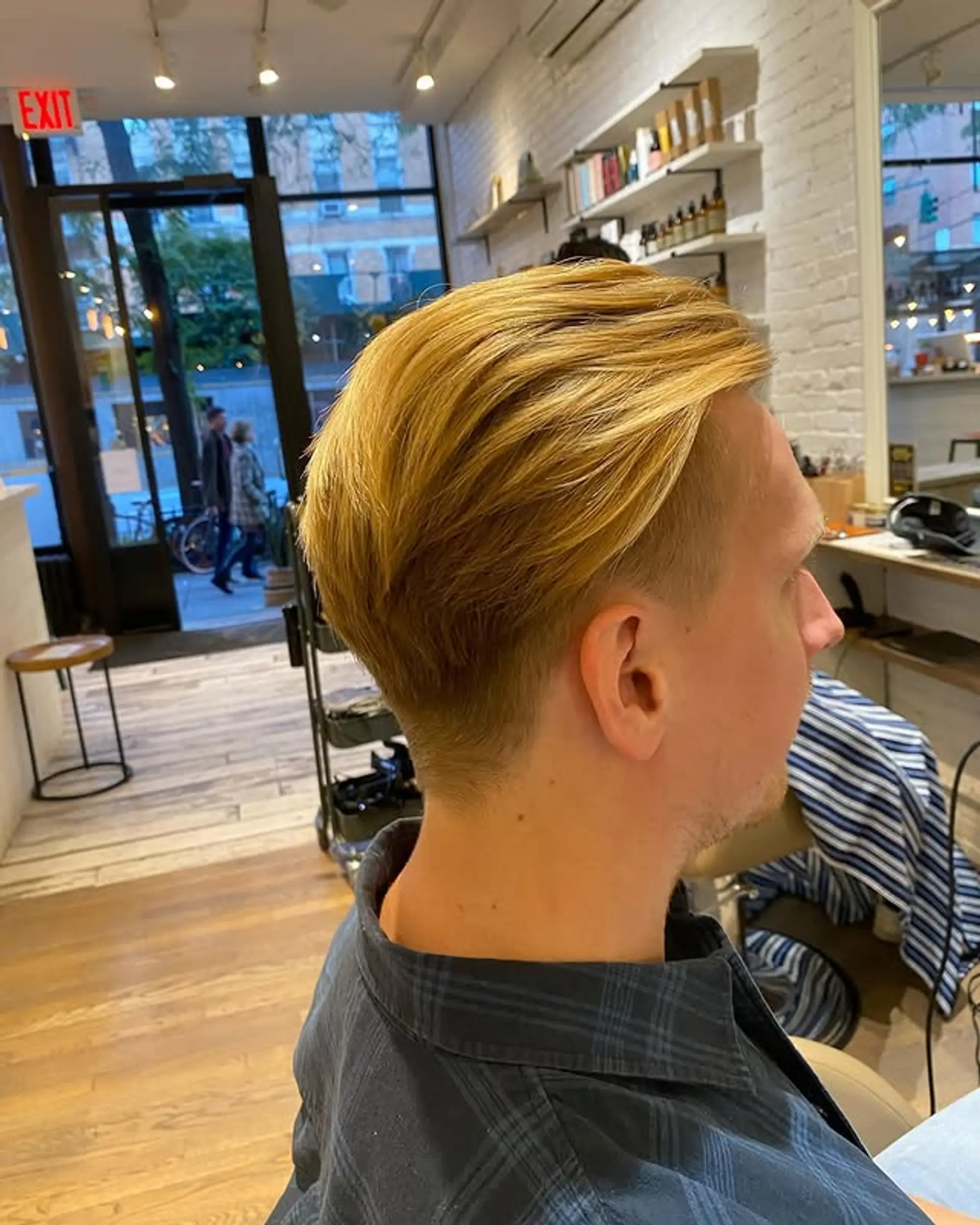 A short, textured hairstyle with a fade and longer hair on top. 1