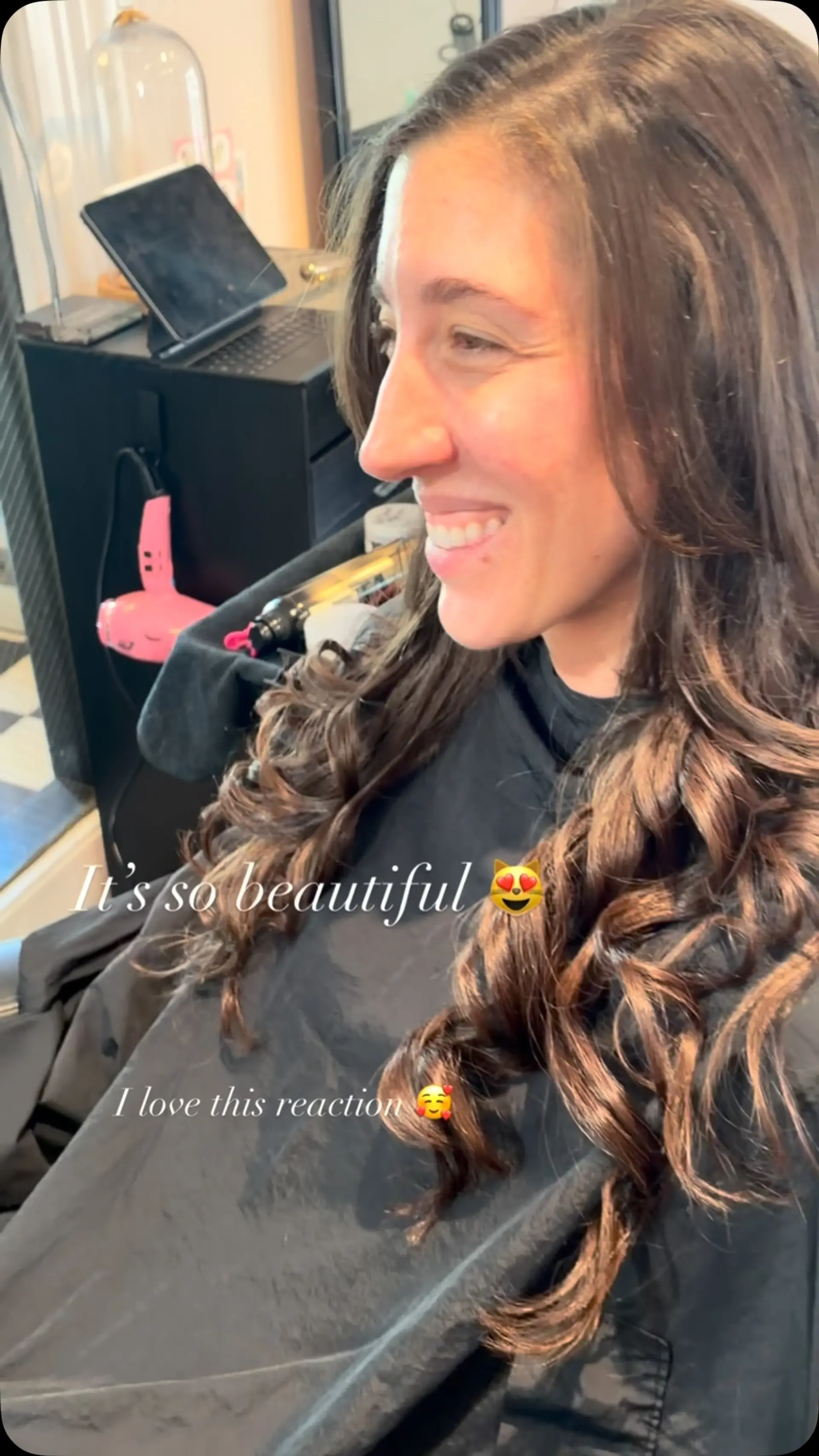 Long brunette hair with full I-tip extensions styled into voluminous, defined spiral curls. 1