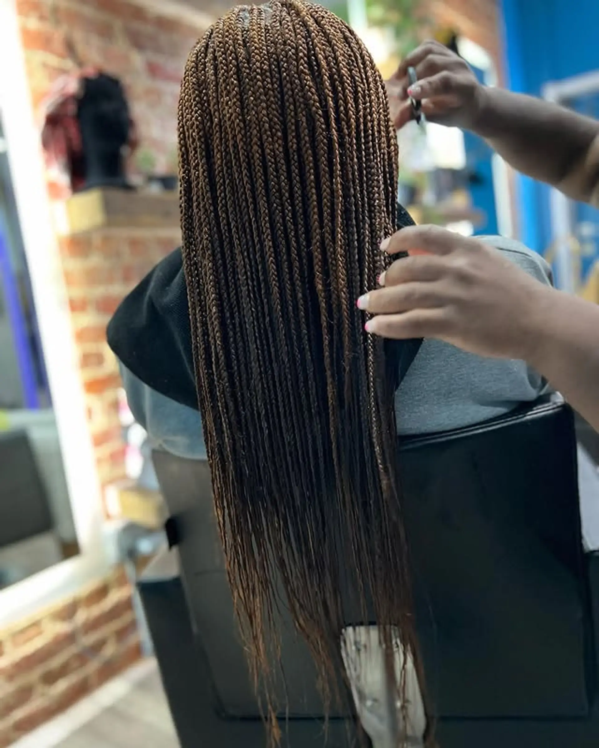 Long, brown box braids that extend to butt length. 1