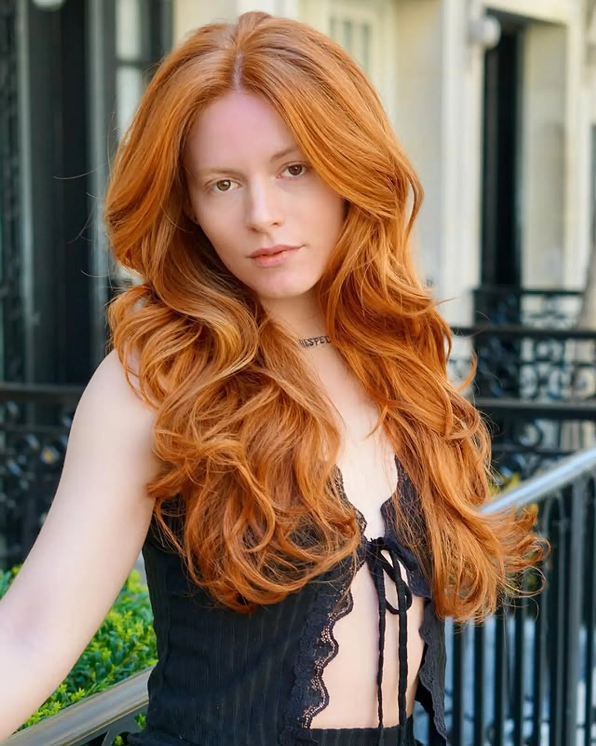 A long, wavy hairstyle with voluminous waves that cascade down, creating a glamorous and sophisticated look. 1