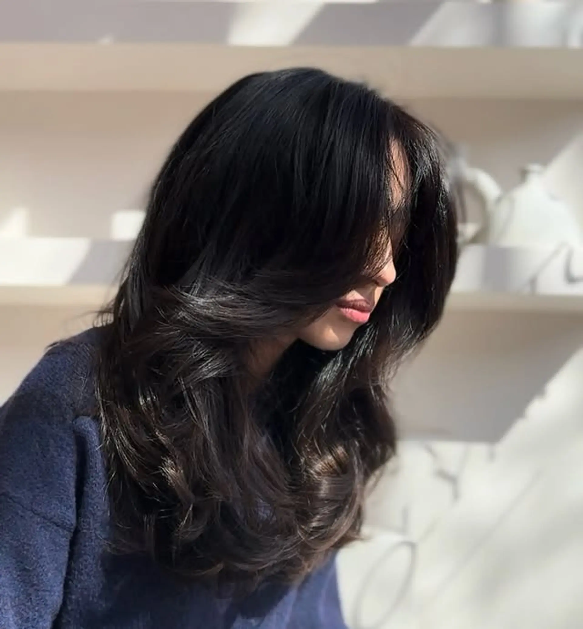 Long, layered wavy hair with face-framing bangs. 1