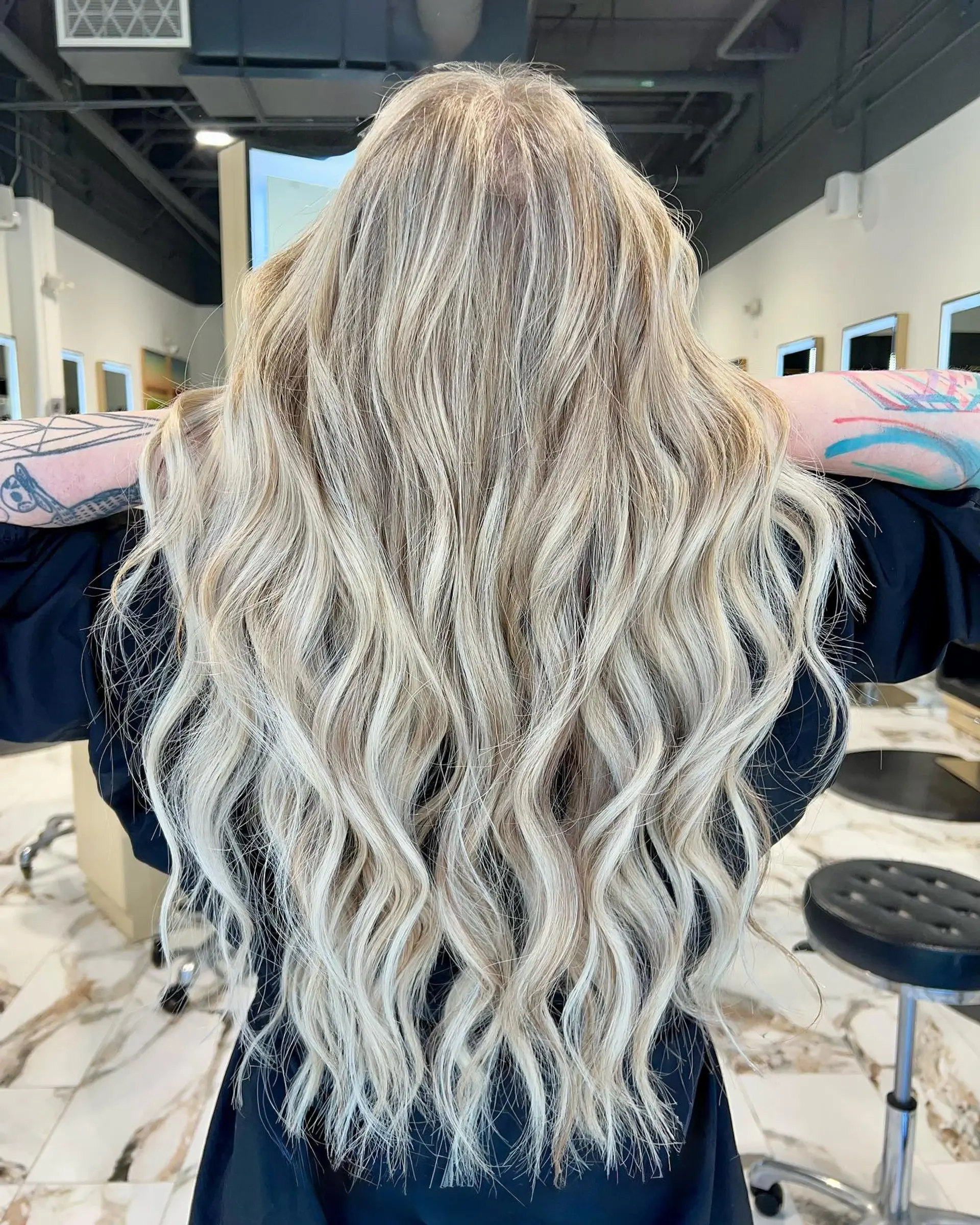 Extra-long dimensional blonde hair styled in soft, loose beach waves. 1