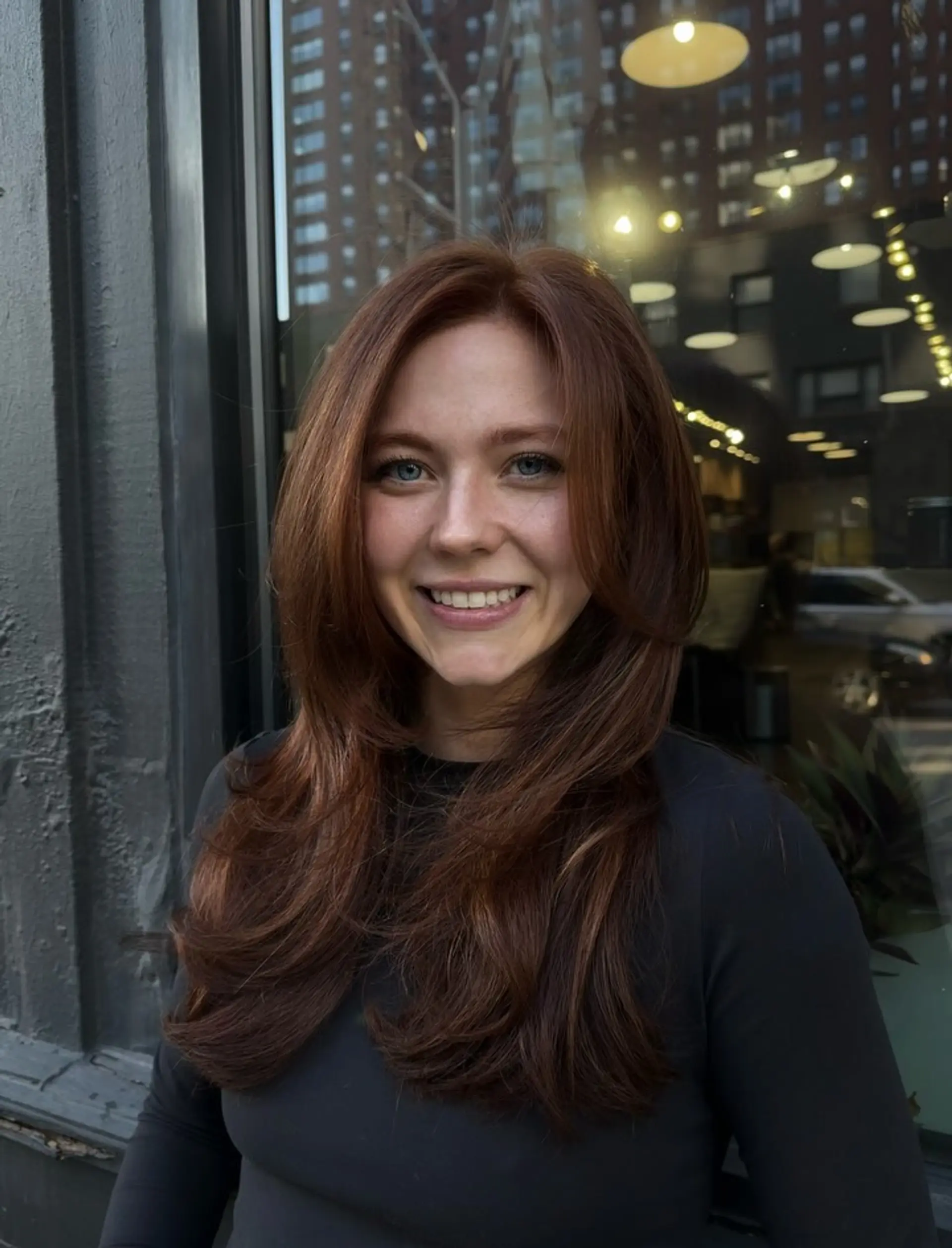 Rich copper long hair styled with soft, face-framing layers and a voluminous, bouncy blowout. 1