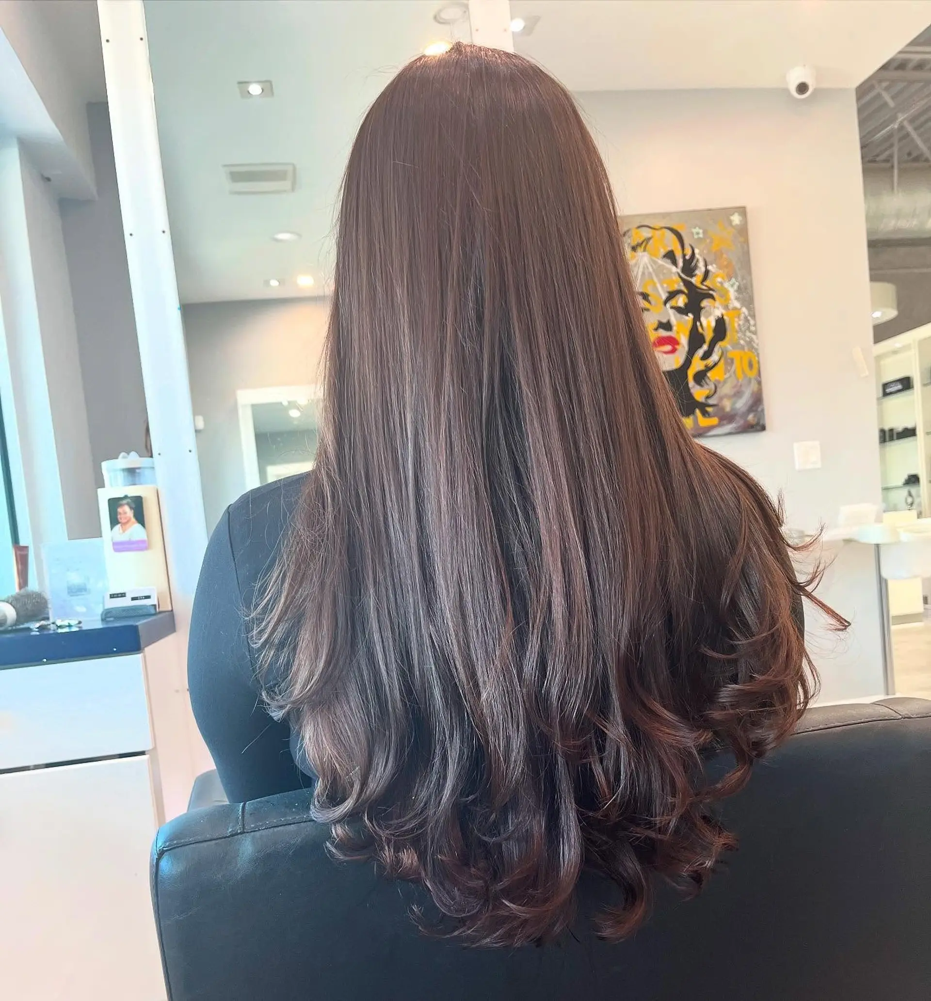 A long, layered hairstyle with soft waves at the ends. 1