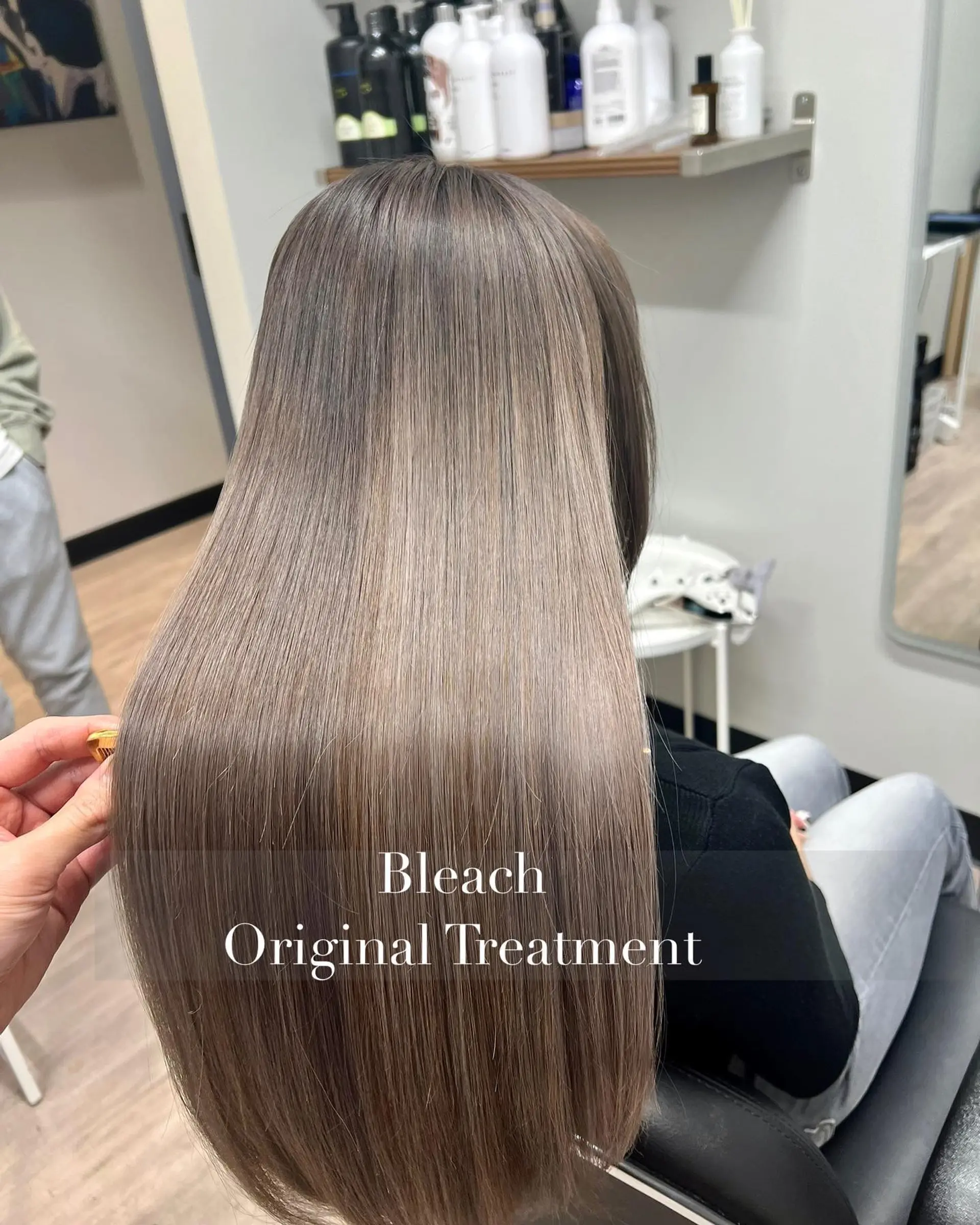 Long, glossy straight hair featuring a smooth finish and a cool-toned ash blonde shade. 1