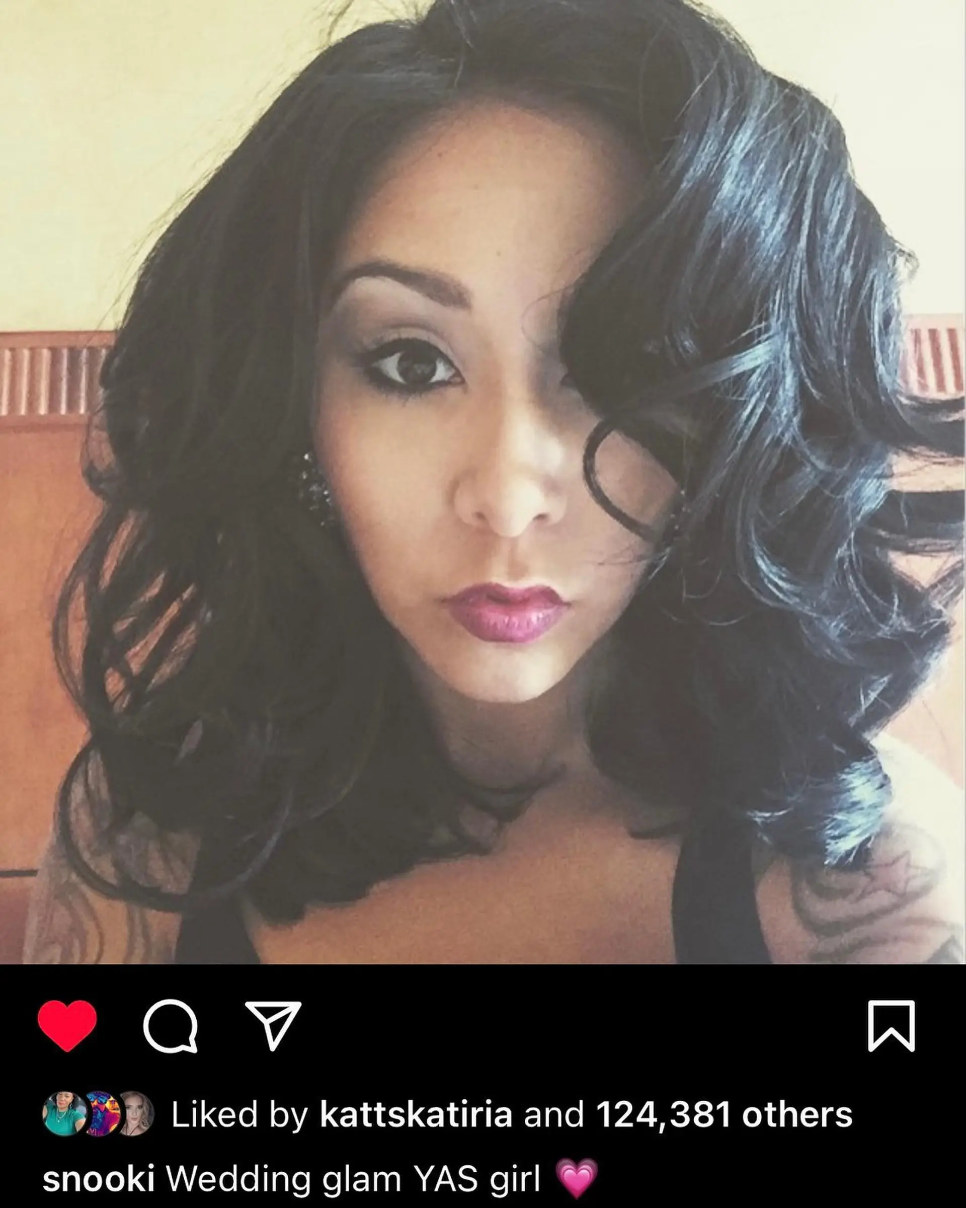 Medium-length dark hair styled with dramatic, high-volume curls and a deep side-swept fringe. 1