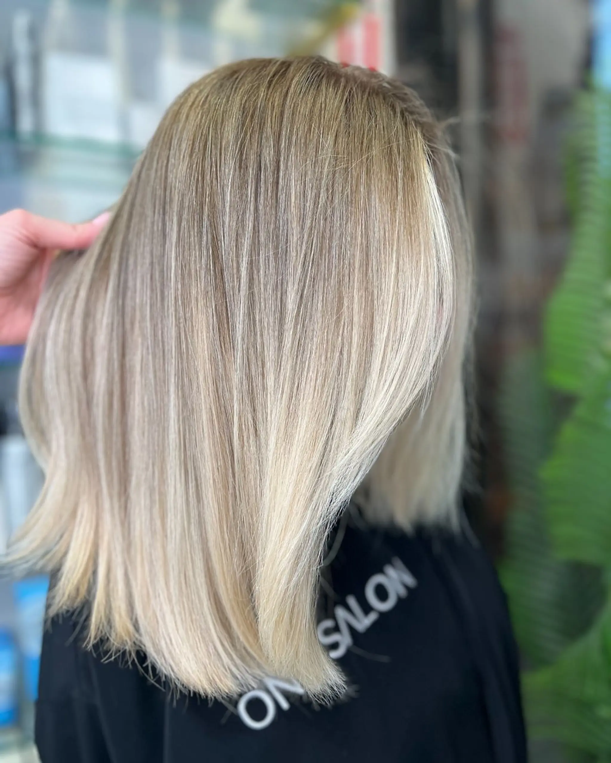 Medium-length, beautifully straightened blonde hair with honey and platinum highlights, glossy sheen, and slightly layered ends.