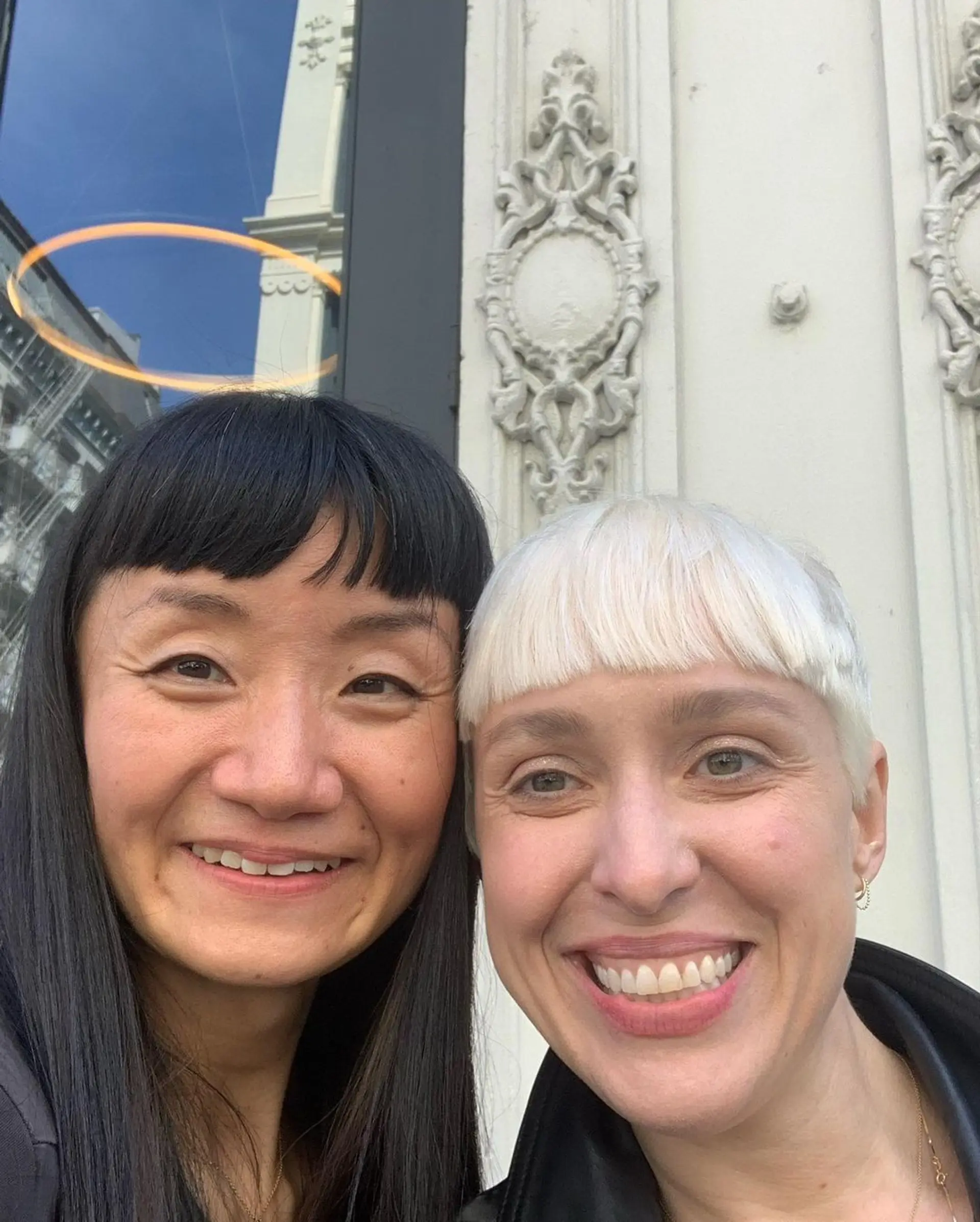 Short, straight platinum blonde hair styled in a pixie cut with distinguishing micro bangs. 3