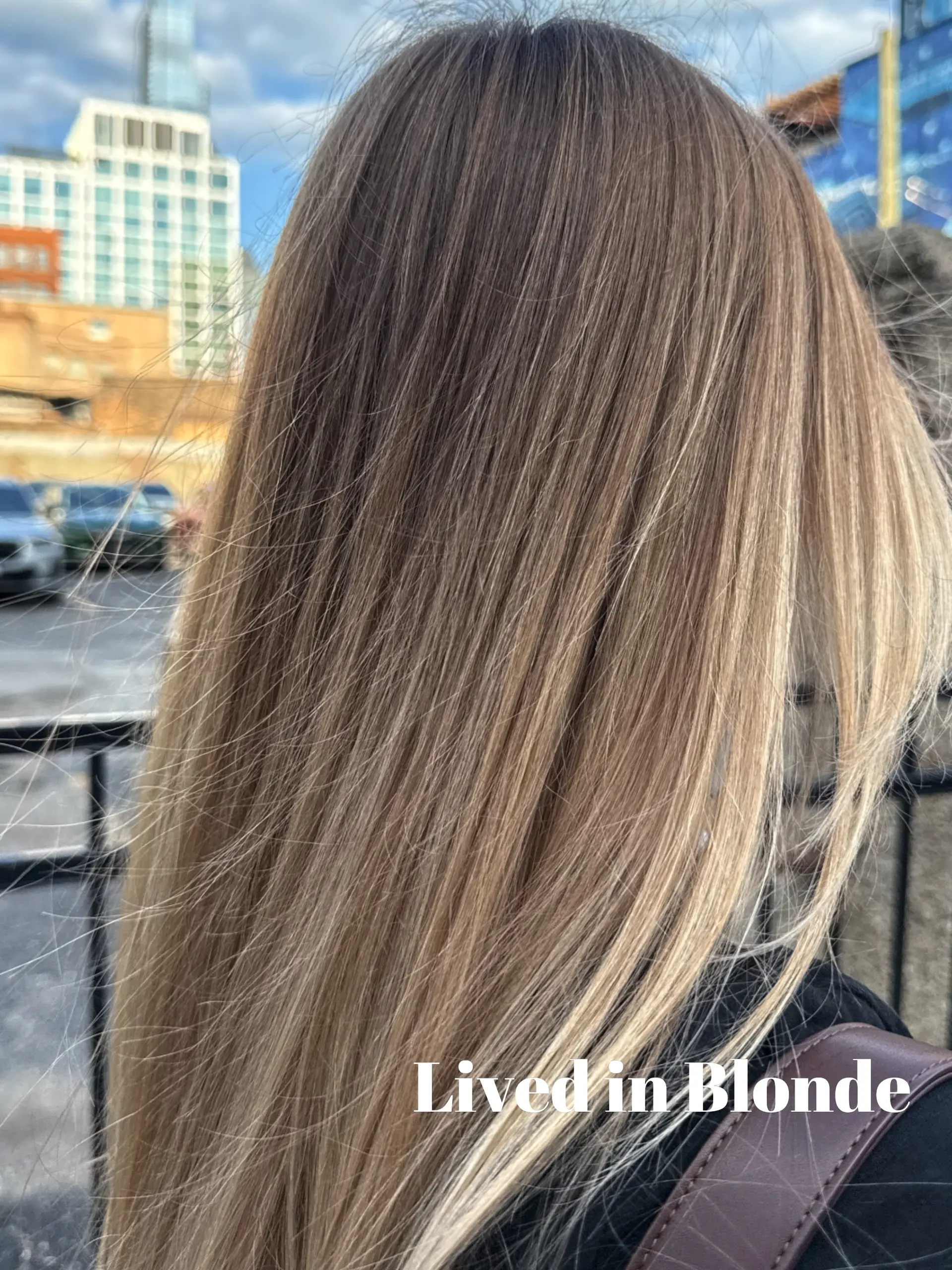 Straight, long hair featuring a seamless lived-in blonde blend with a natural shadow root and bright blonde ends. 1