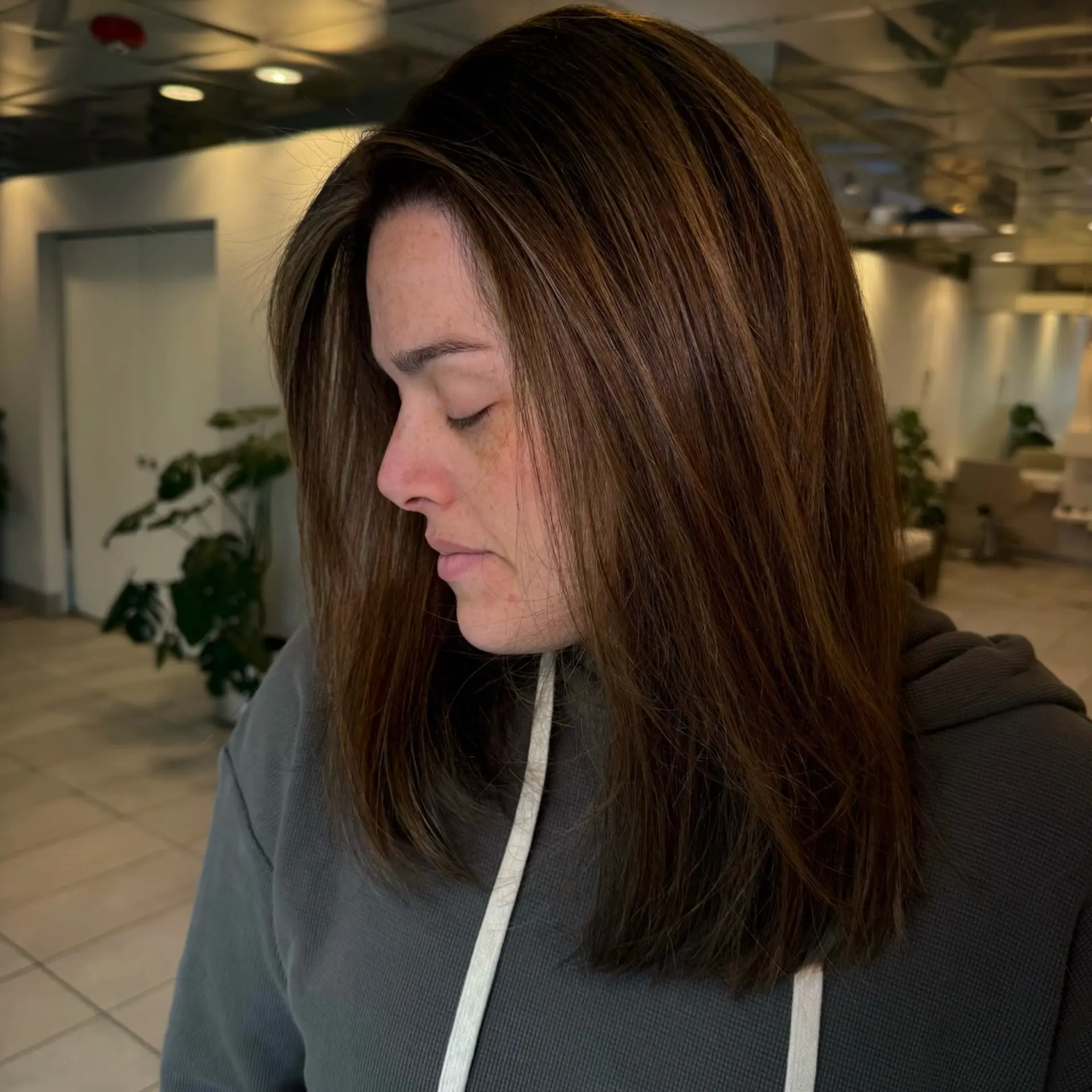 Shoulder-length straight brunette hair enhanced with fine, subtle balayage highlights and a delicate face-framing money piece. 1