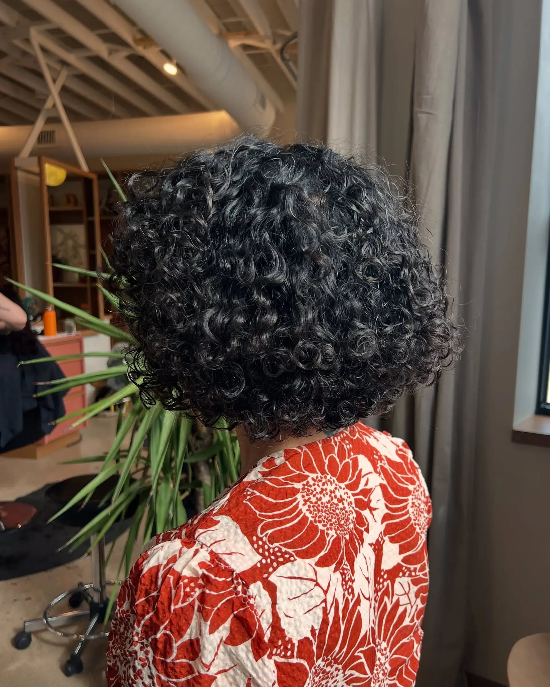 A classic short bob, styled with natural, defined curls that create a voluminous shape. 2