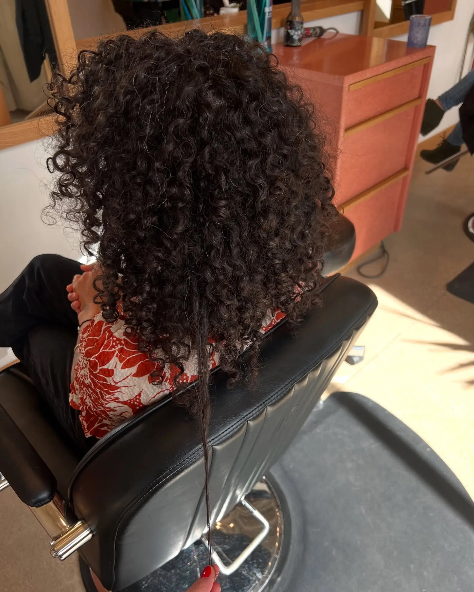 A classic short bob, styled with natural, defined curls that create a voluminous shape. 3