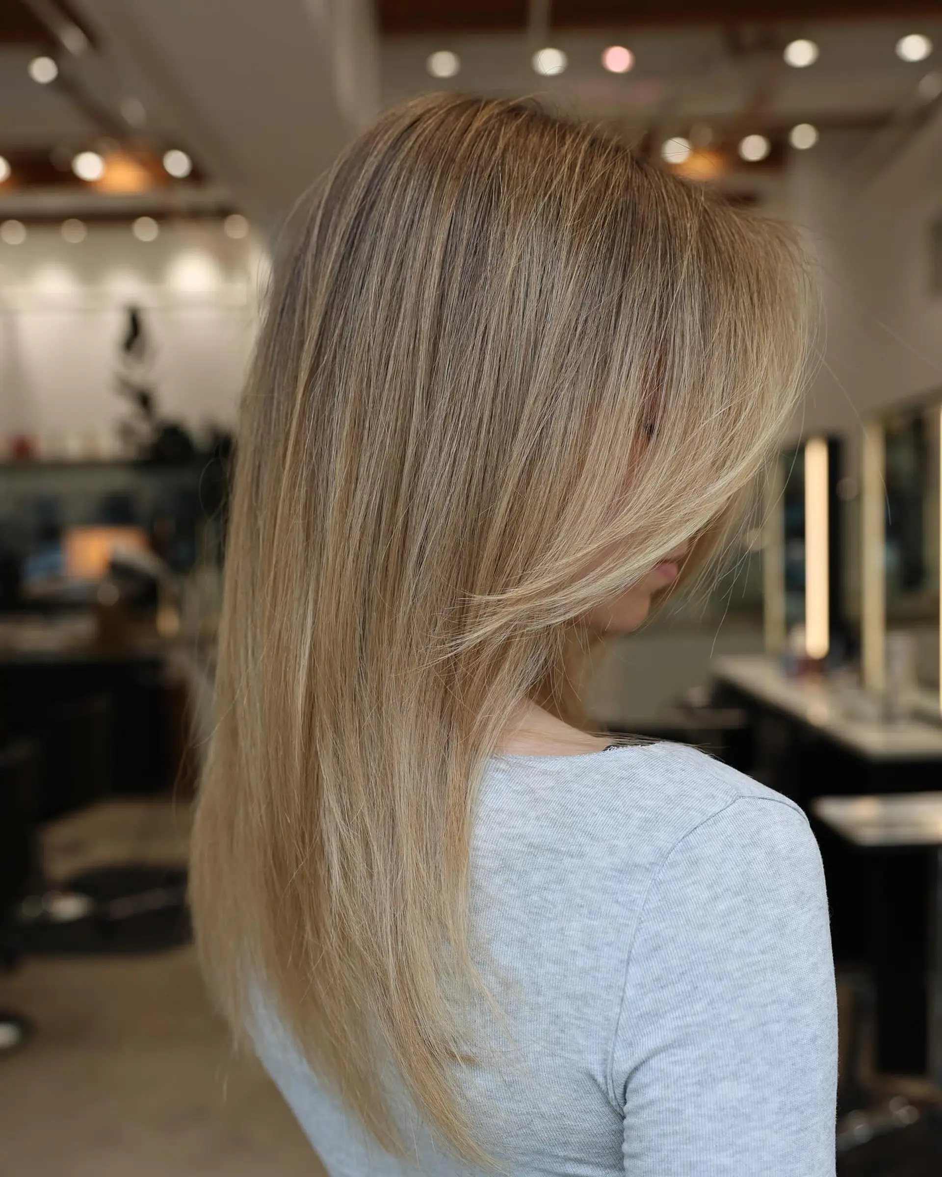 A long layered haircut with face-framing layers for straight hair. 2